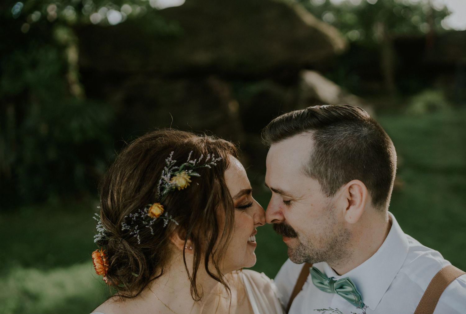 Intimate moment shared between newlyweds during garden wedding celebration.
