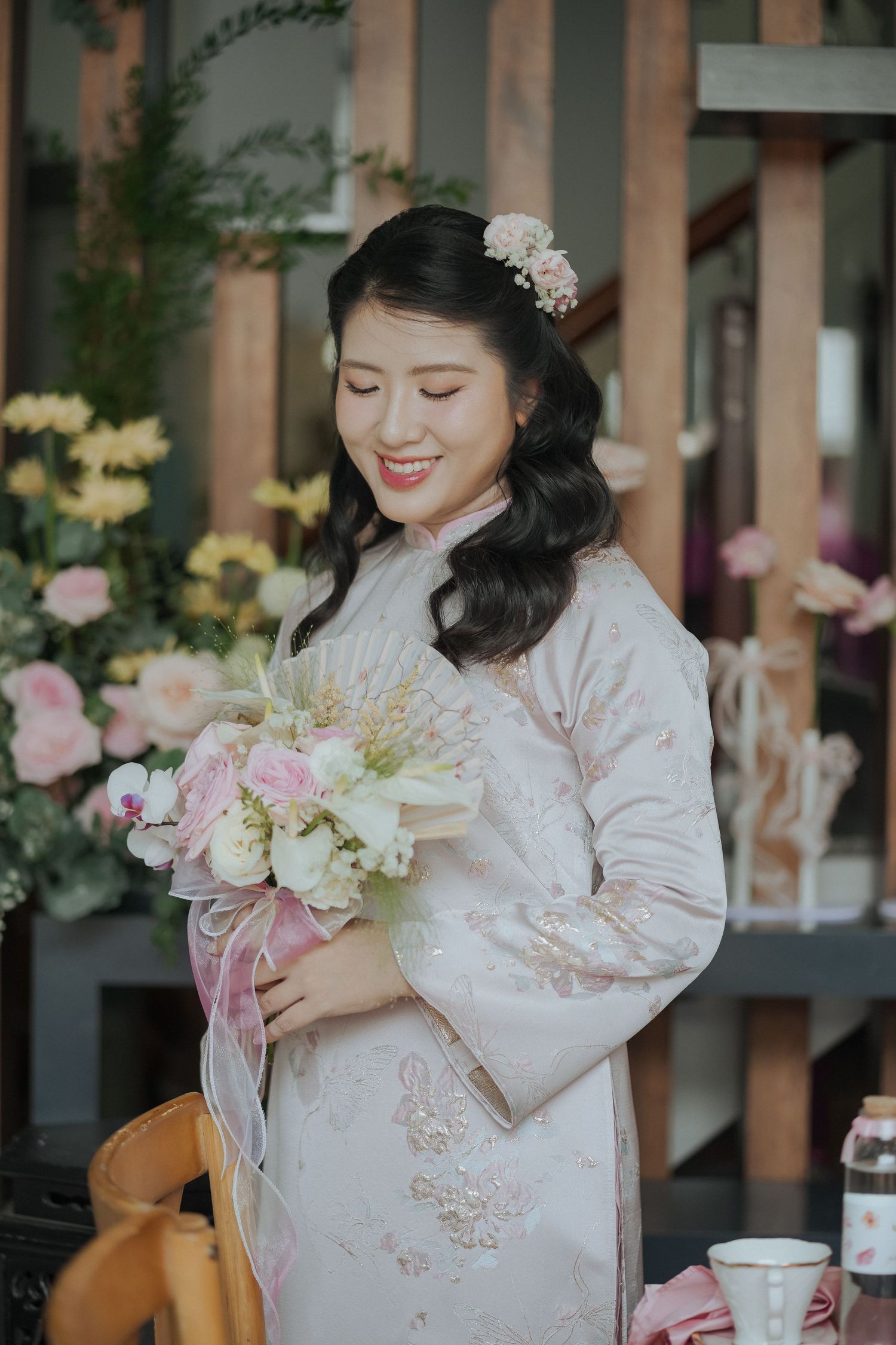 Traditional wedding attire with delicate pink and white floral bouquet.
