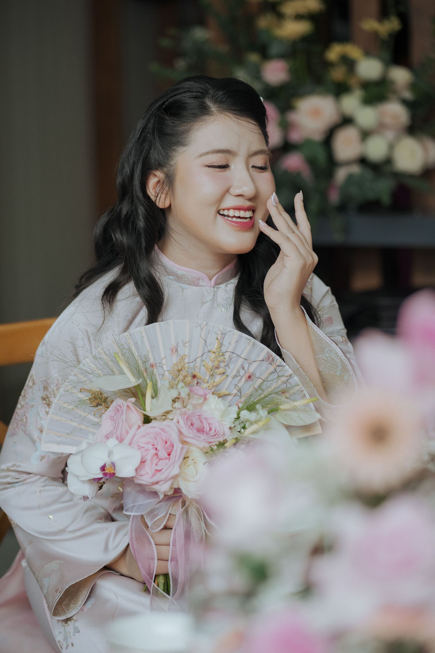Elegant tea ceremony setting with pink roses and traditional decor.