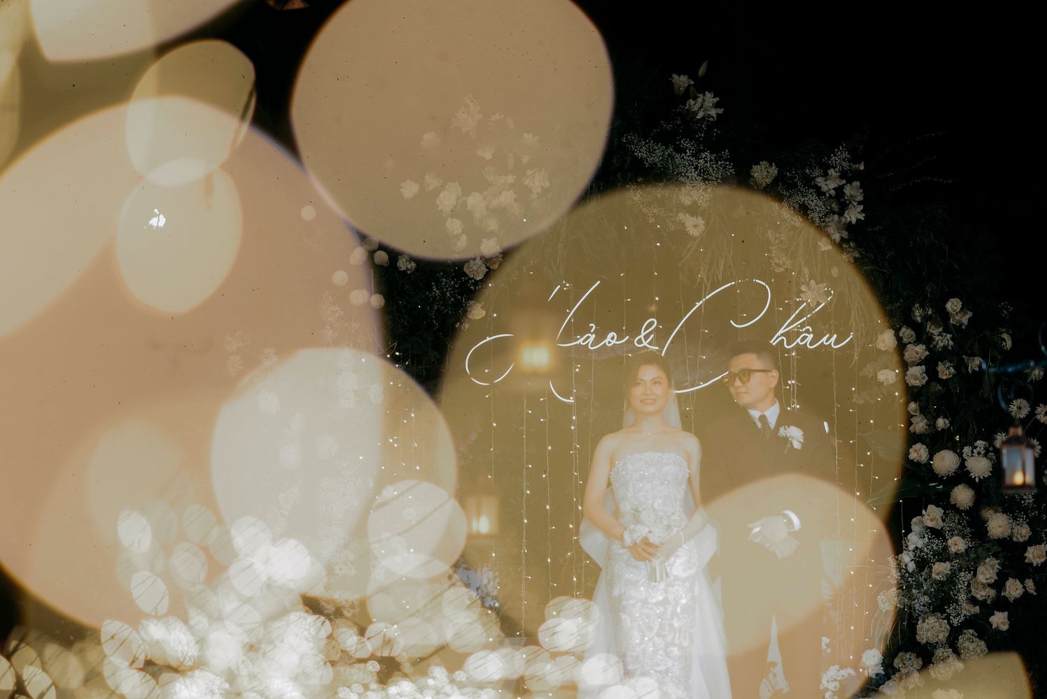 Dreamy vintage-style wedding photo with bokeh light effects and soft overlays.