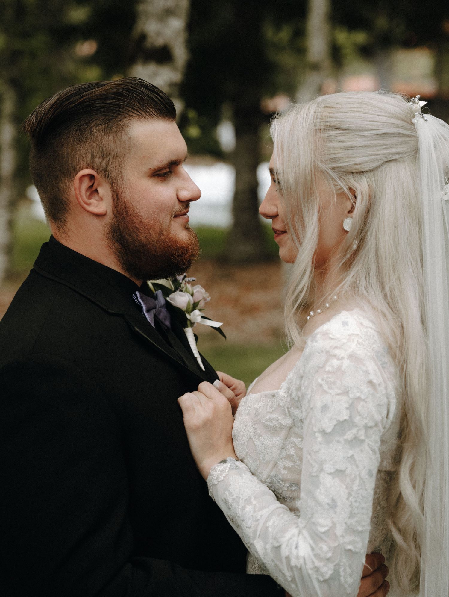 A series of romantic wedding photos showing a couple in a close embrace with the bride wearing a long-sleeved lace gown.