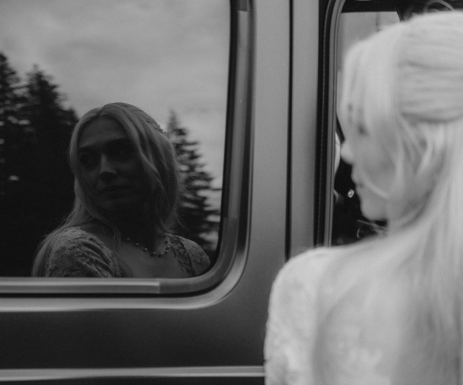 Black and white portraits showing the profile of someone through a car window.