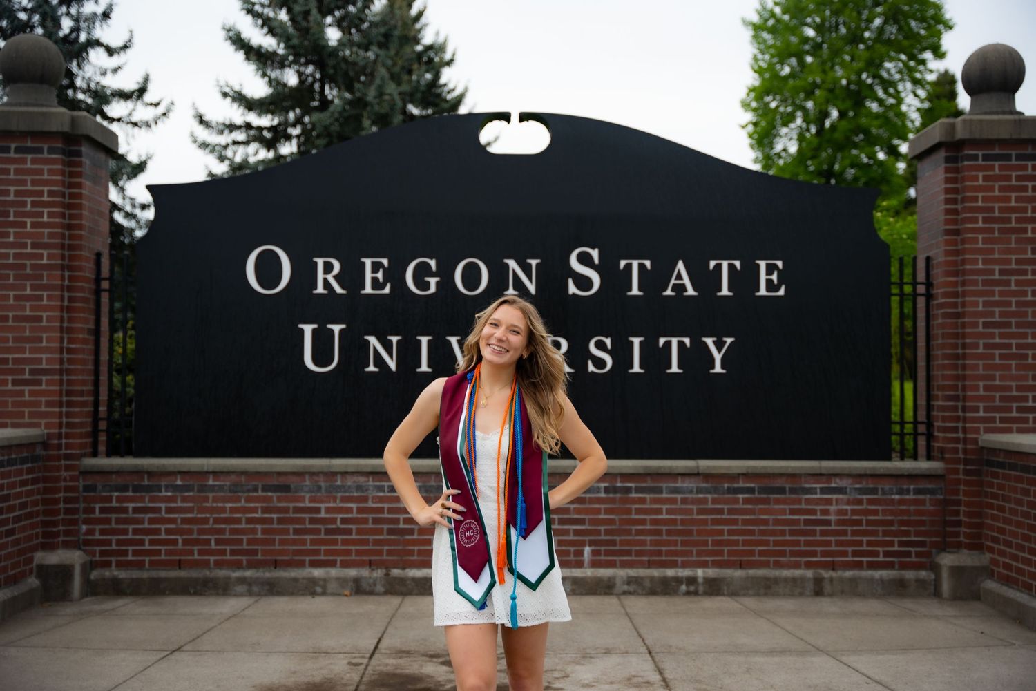 Five identical Oregon State University entrance signs mounted on brick walls are shown in a horizontal row.