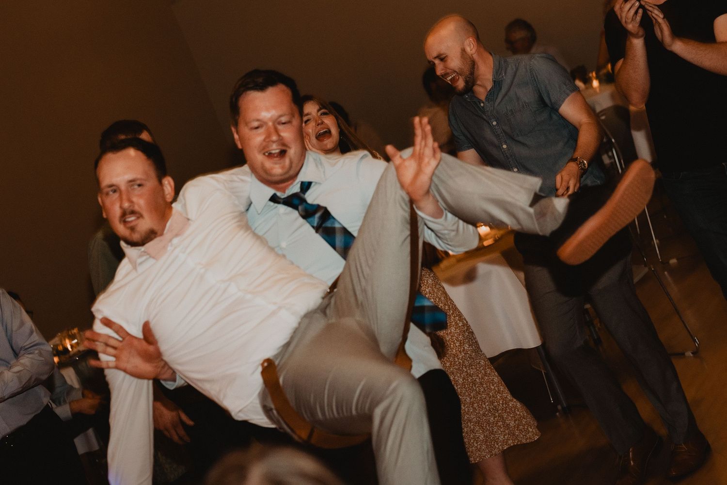 People dancing and celebrating at a wedding reception create a lively and energetic party scene.