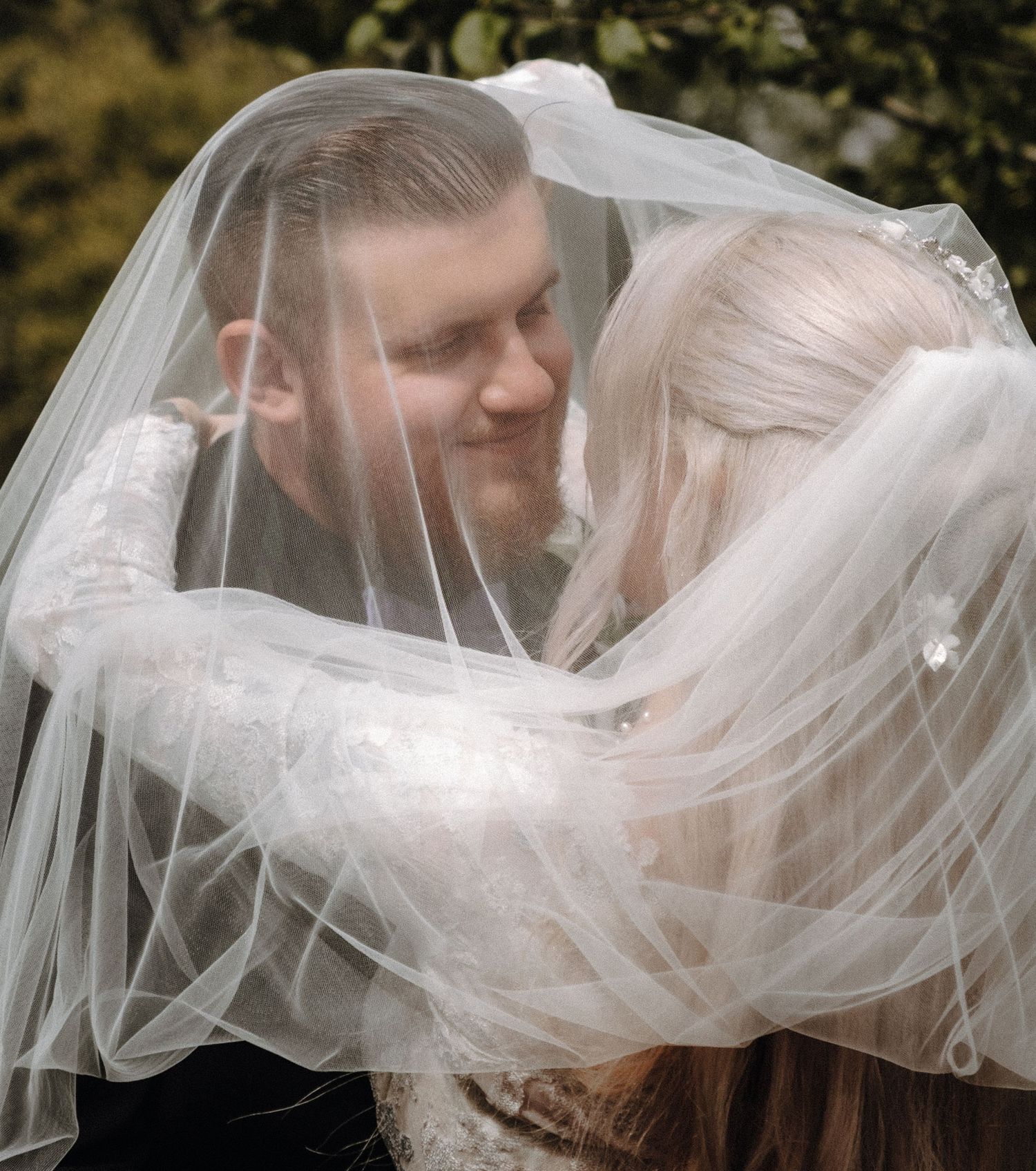 A flowing white wedding veil caught in a romantic breeze during a photo session.