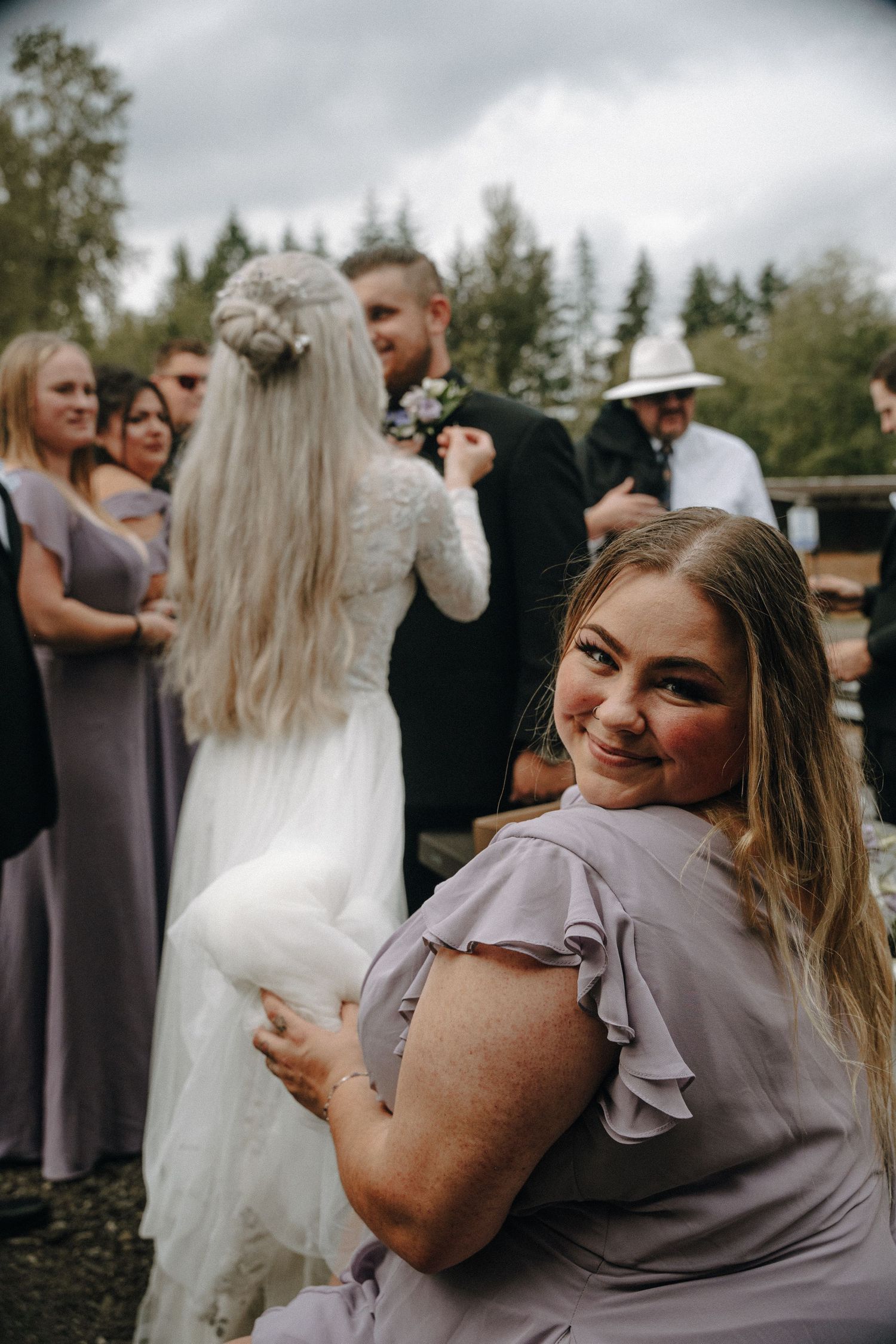 People sharing emotional moments at an outdoor wedding celebration in a series of candid photos.