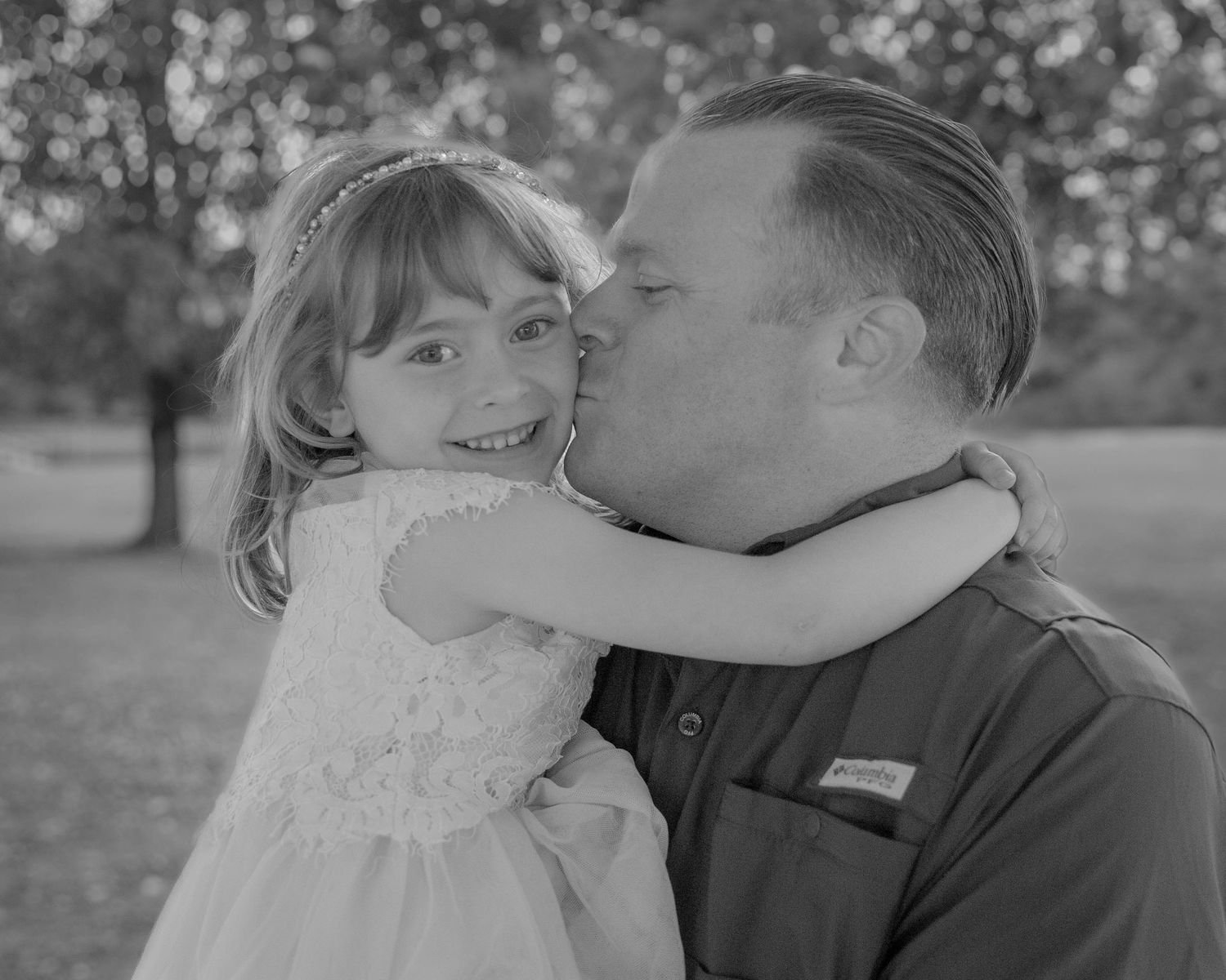 Black and white portrait series showing tender moments between dad and daughter.
