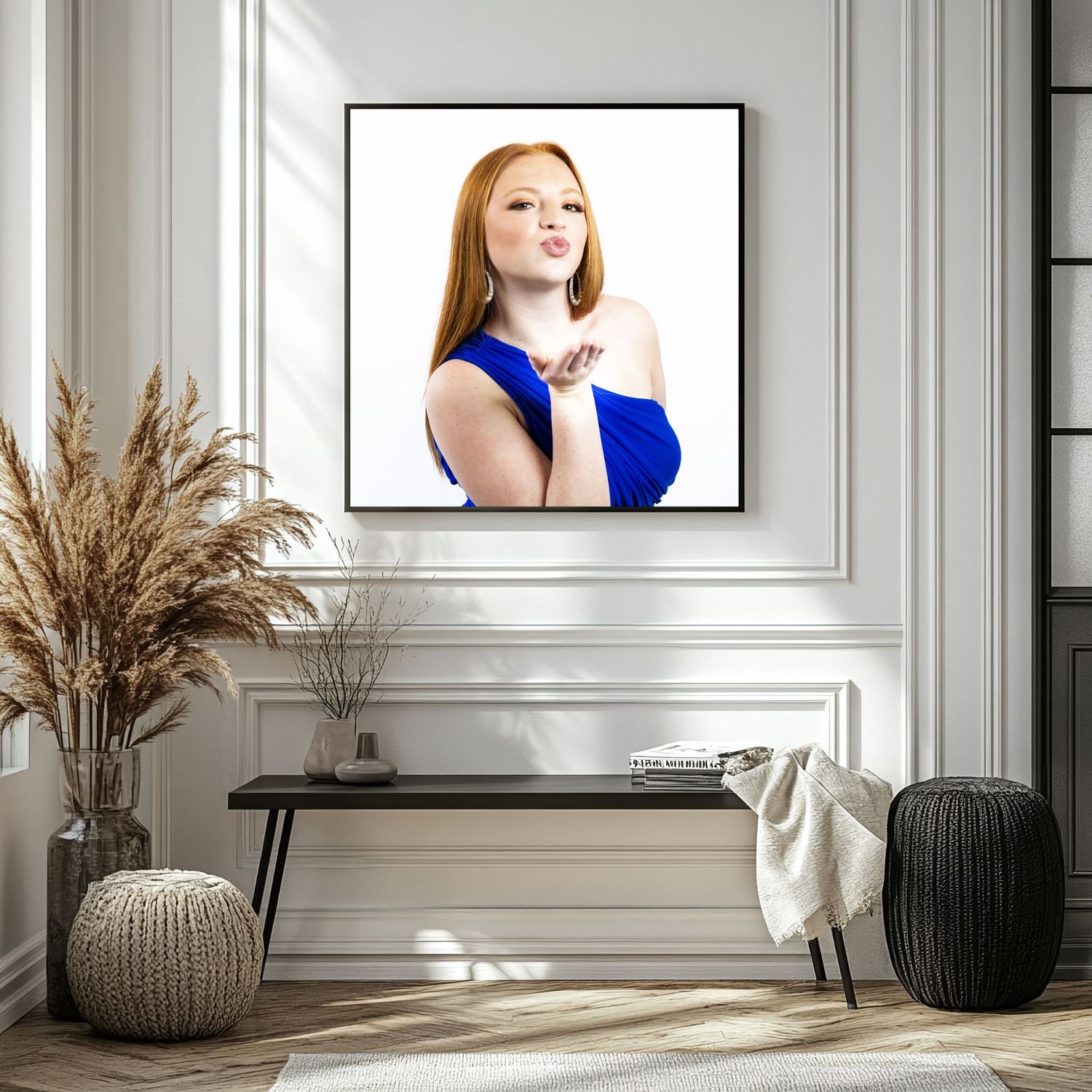 Modern interior with framed portraits and dried pampas grass decor.