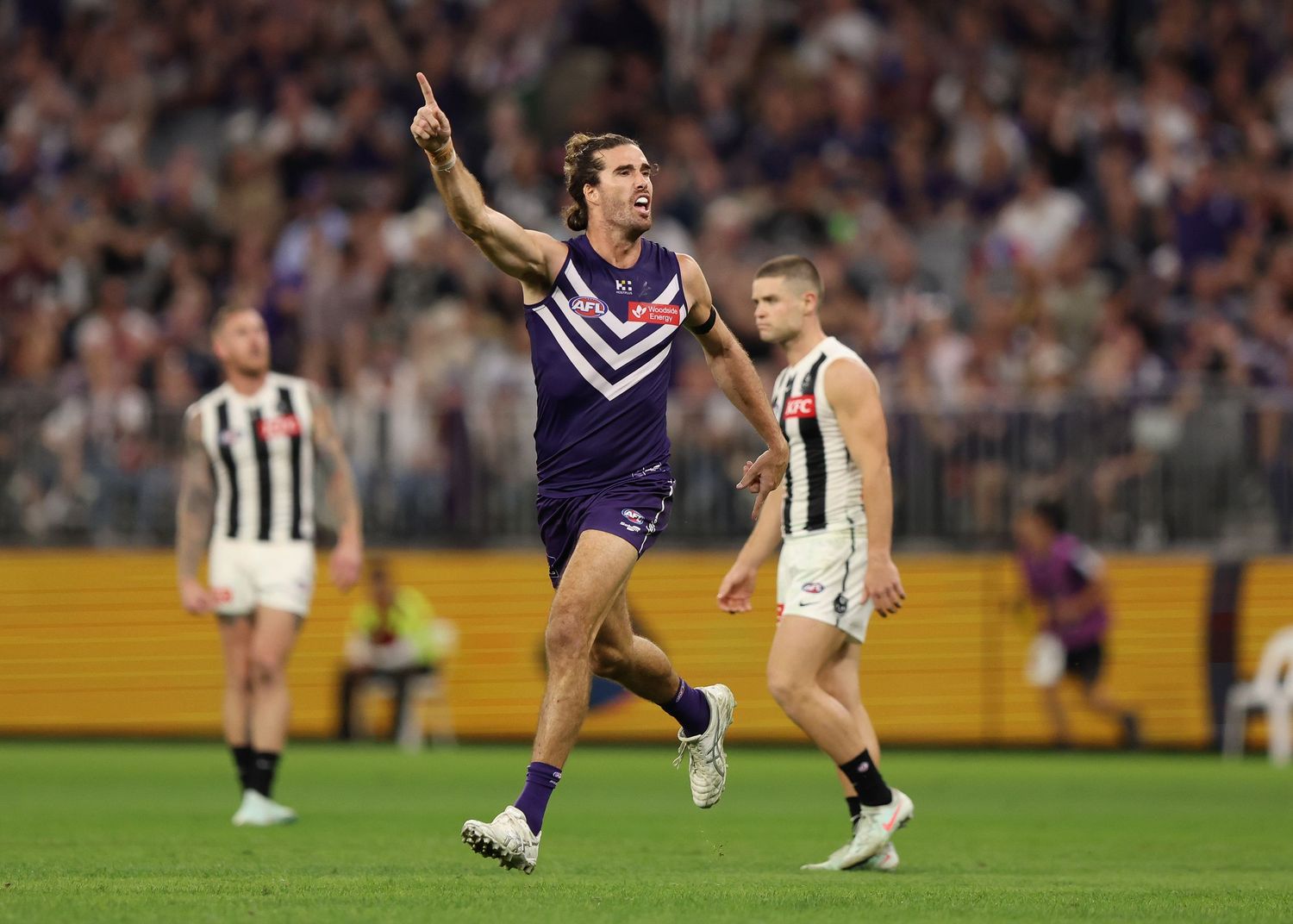 Fremantle player celebrates a goal during AFL match against Collingwood.