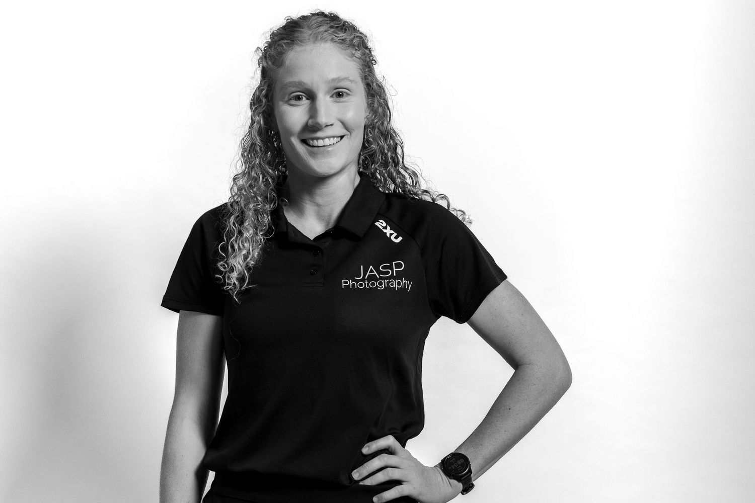 Professional portrait of someone wearing a black polo shirt with JASP photography logo in black and white format.