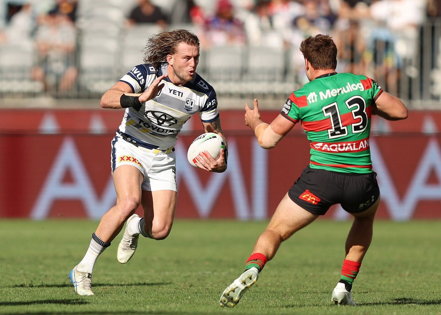 Two rugby players face off during intense match action.