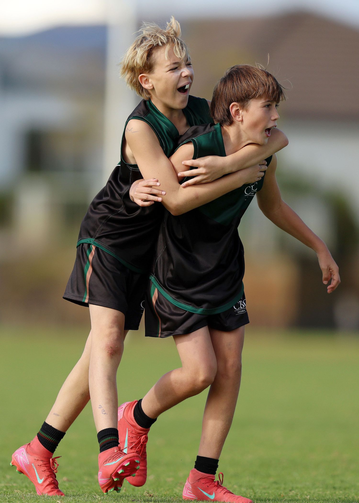 Sequence of action shots showing soccer player in green jersey performing slide tackle on grass field.