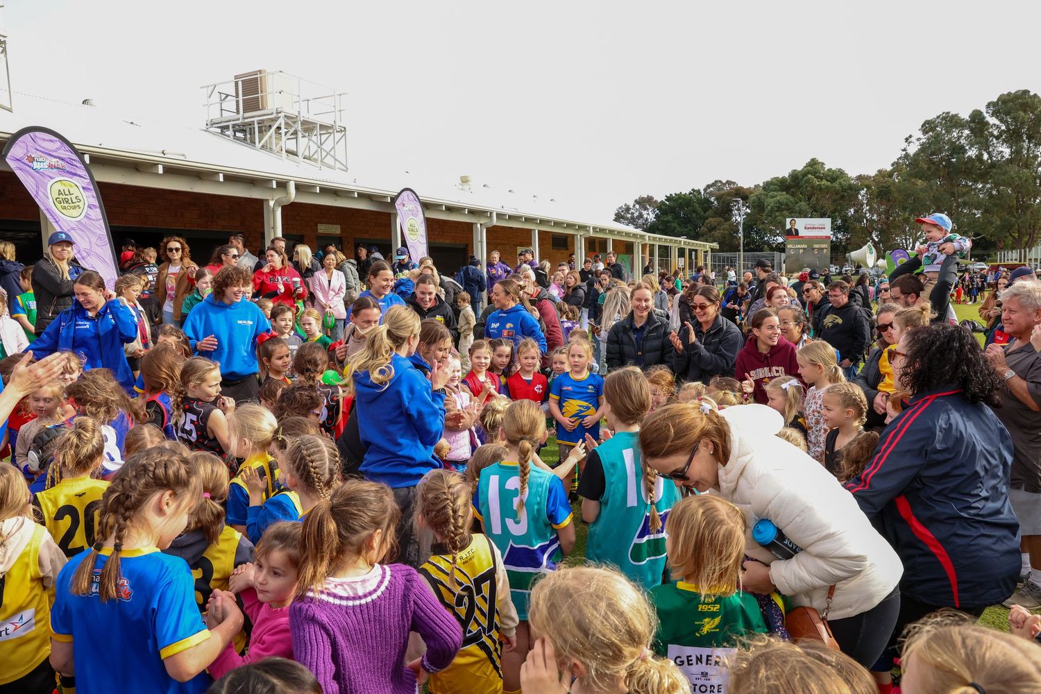 A large group of students gathered outside a building during a school celebration.