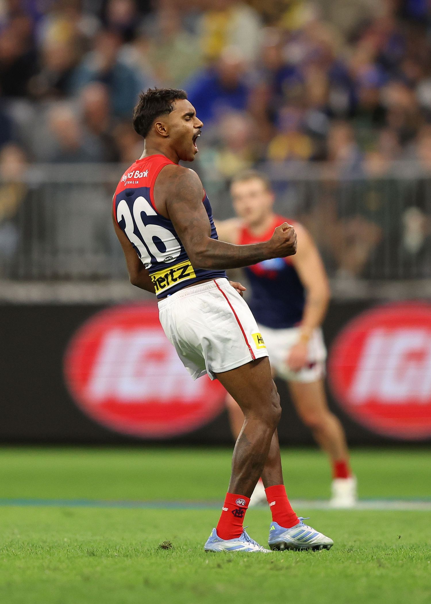 AFL player celebrates passionately after scoring during the match.