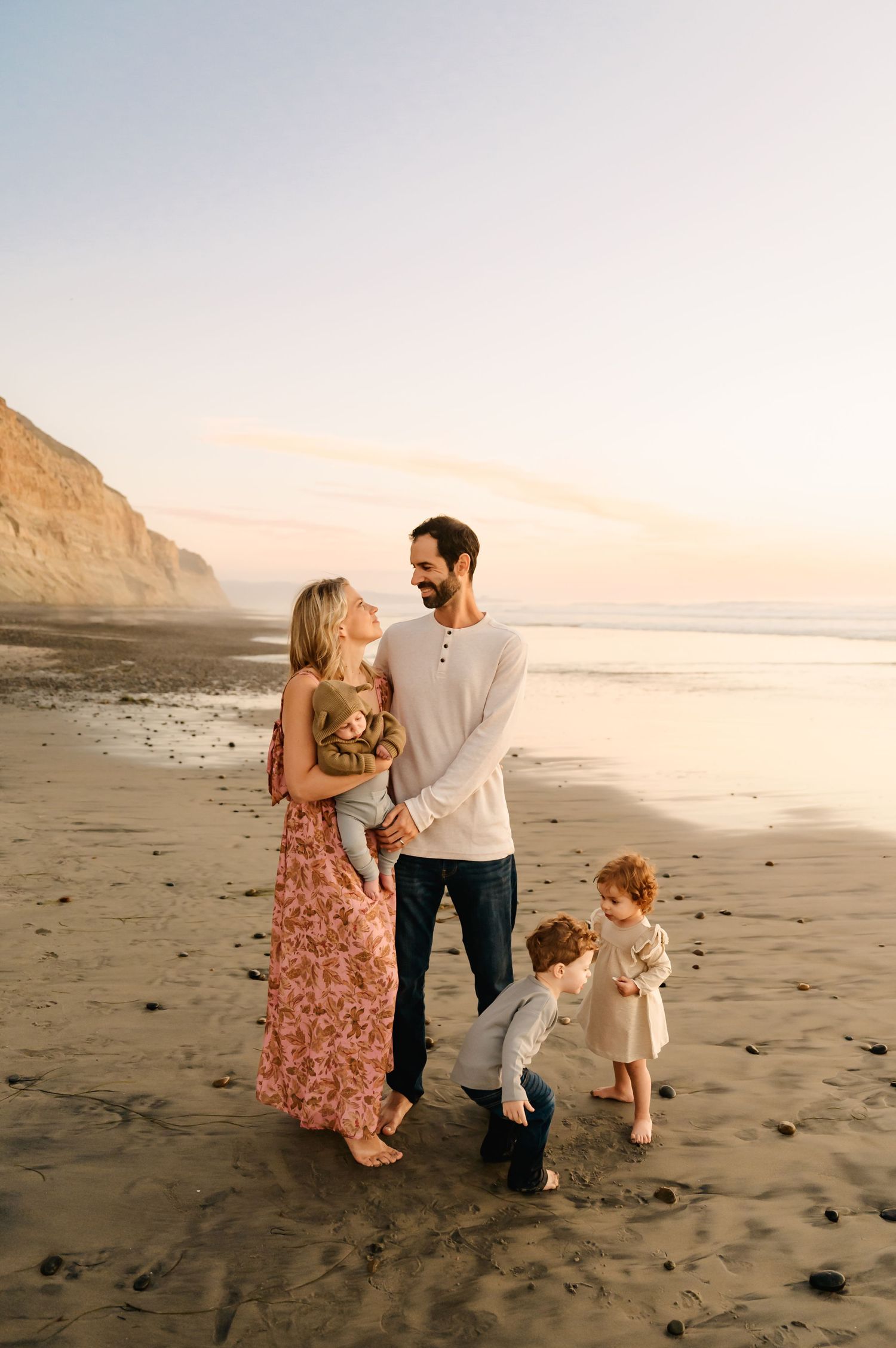 A family walking on Malibu beach at sunset during family photoshoot by Thousand Oaks family photographer