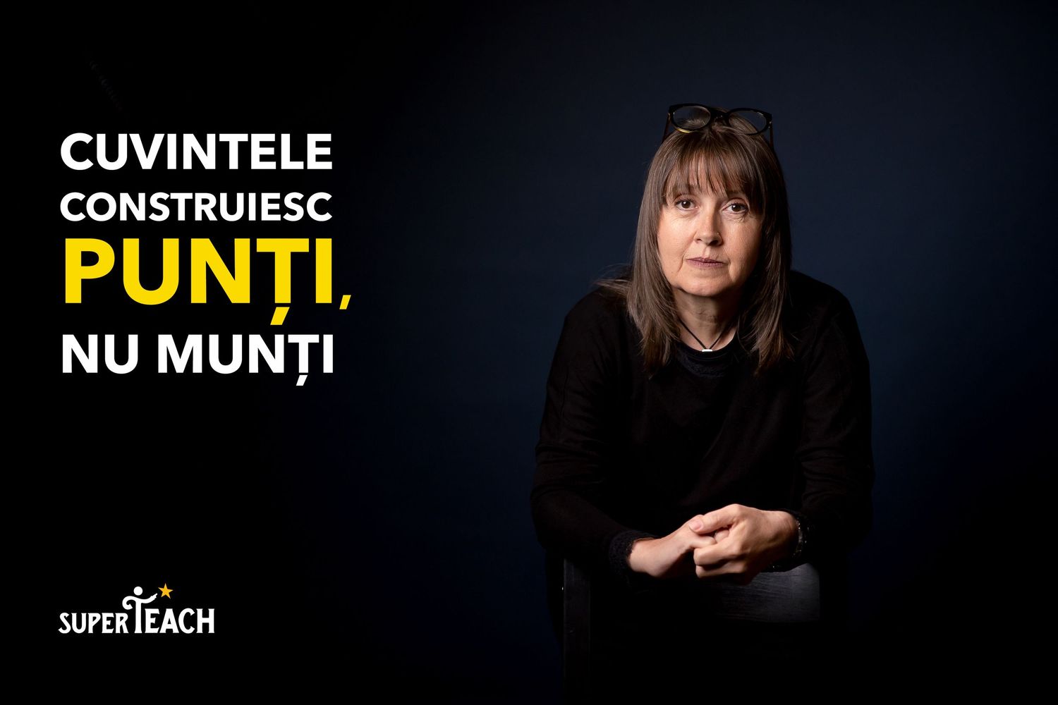 Woman in black seated against dark background with Romanian text reading words build bridges not mountains by SuperTeach.
