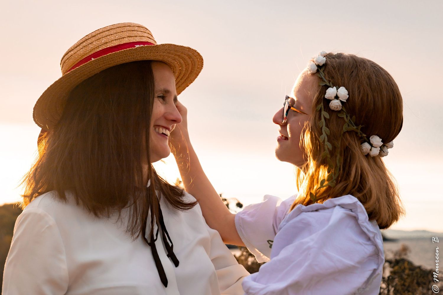 A mother and daughter share a tender moment at golden sunset, girl wearing flower crown.