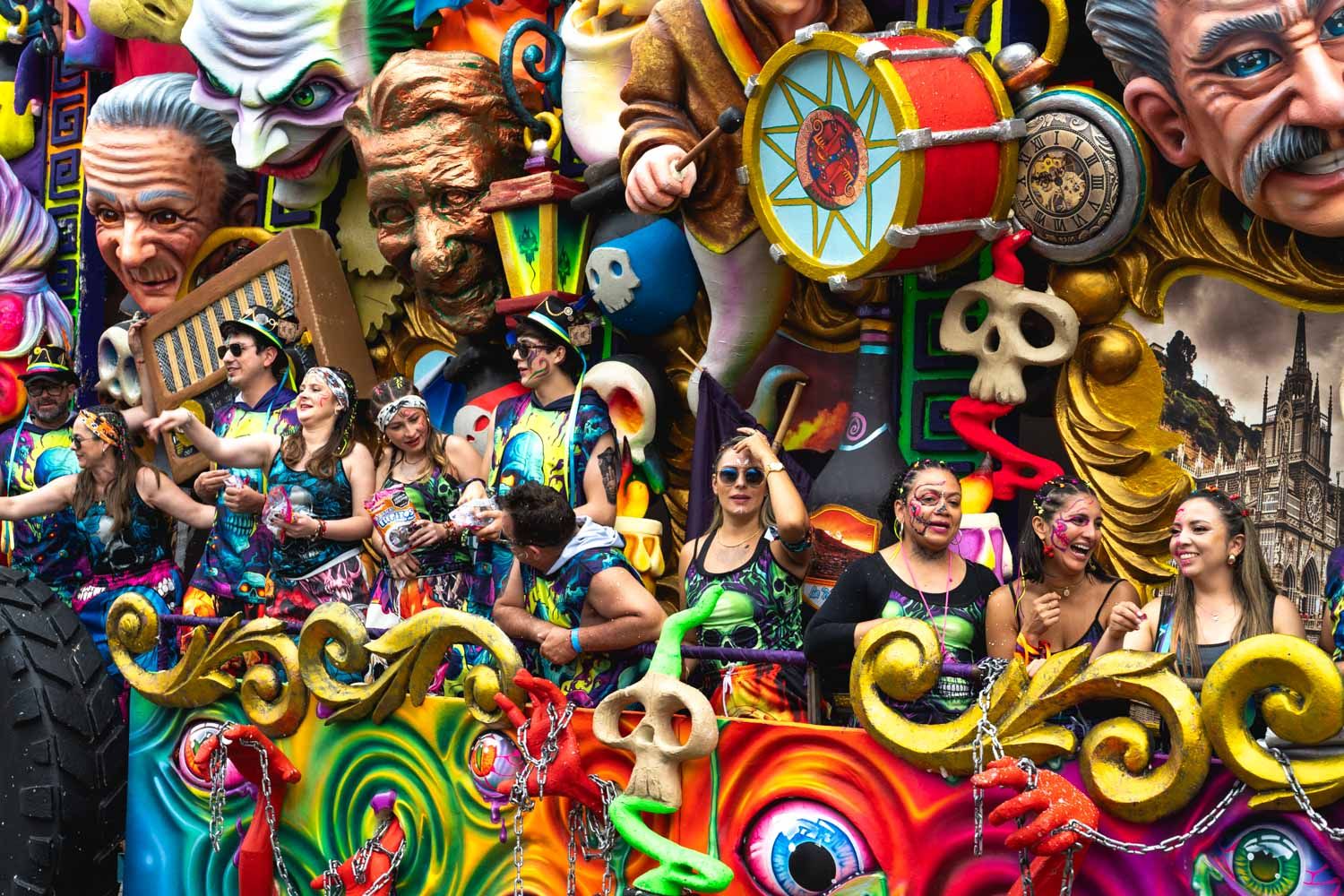 Participants of a carnival float enjoying witnessing the crowds.