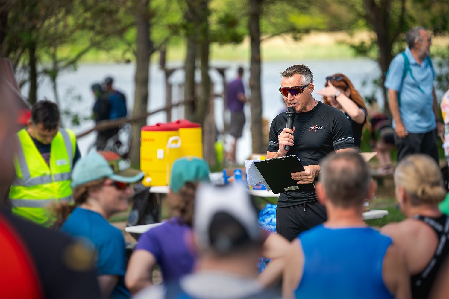 The event organiser addressing a crowd with a microphone.
