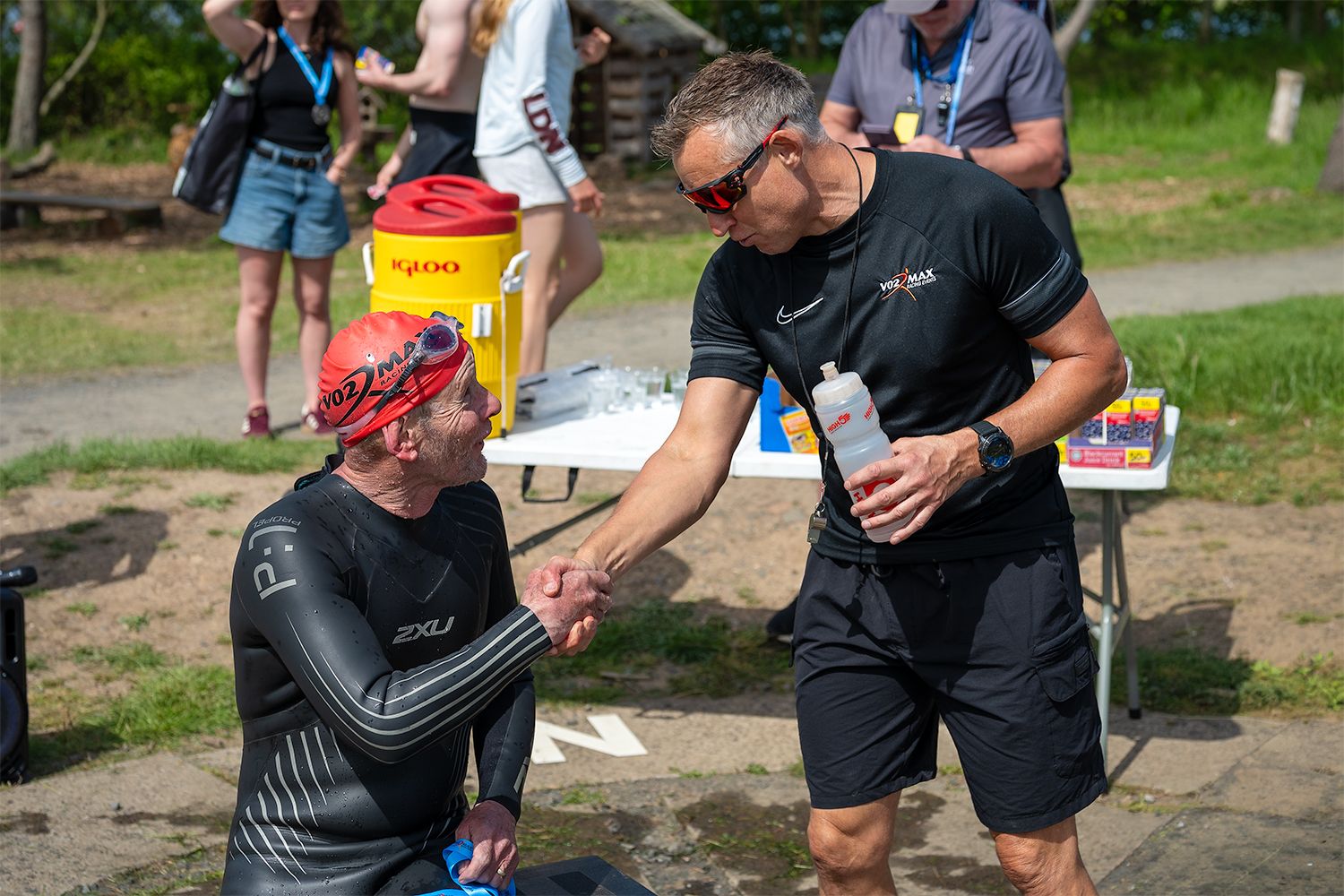 Event organiser shaking hand of a participant of the race event.
