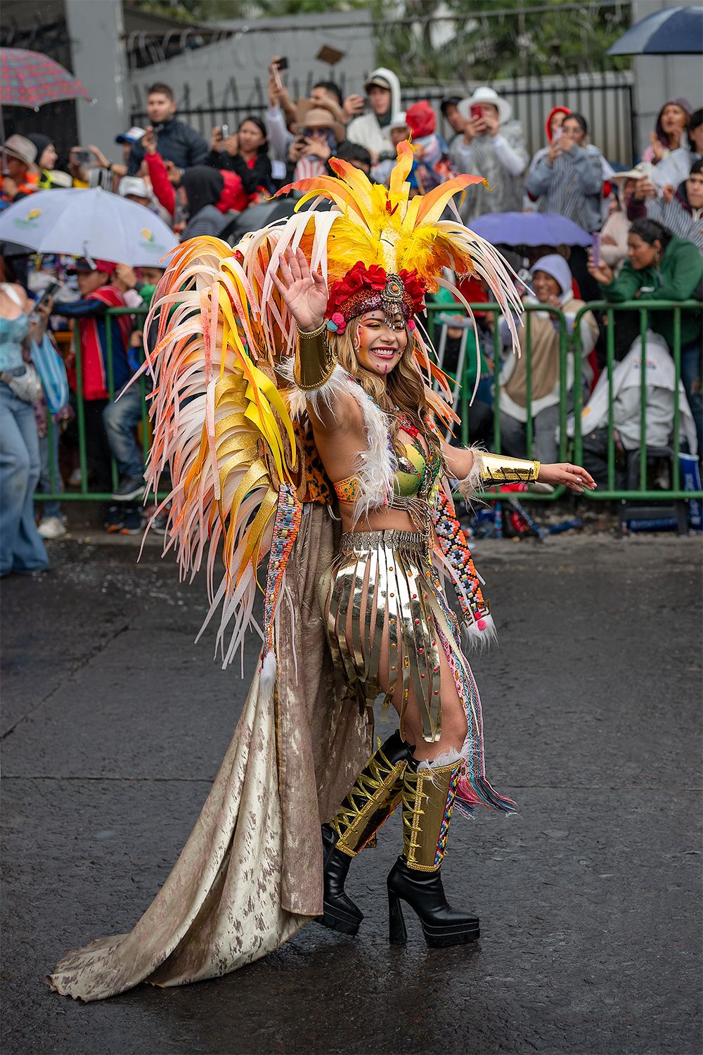 Full body portrait of a participant of the carnival, wearing a very colourful outfit.