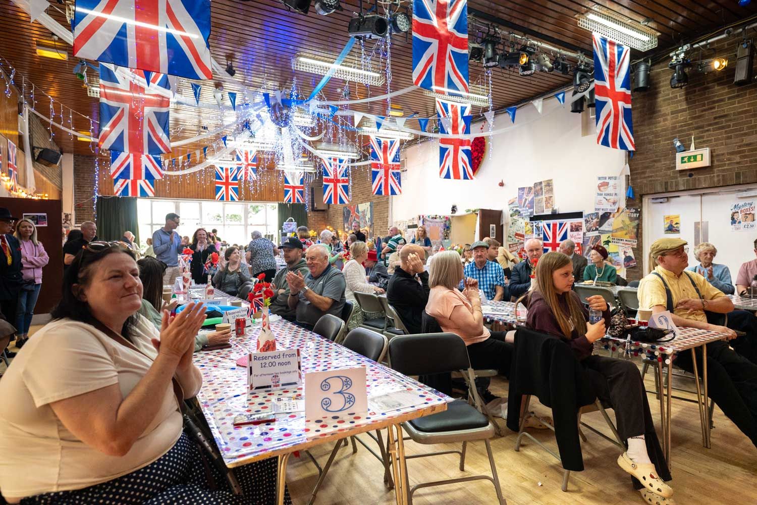 Many people enjoying the entertainment inside the village hall.