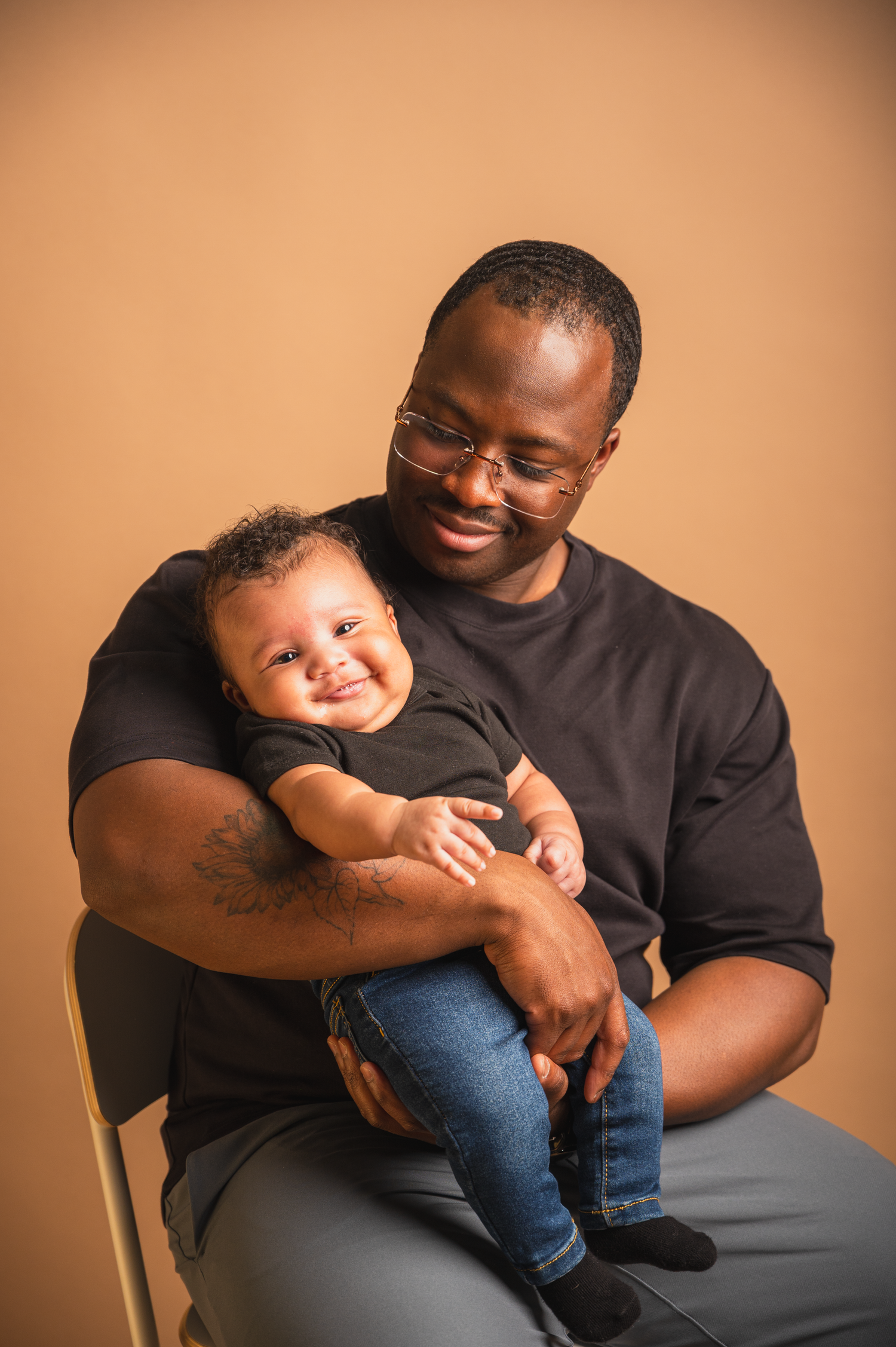 Father holding his newborn baby, nose-to-nose profile shot during a studio session in Edmonton.