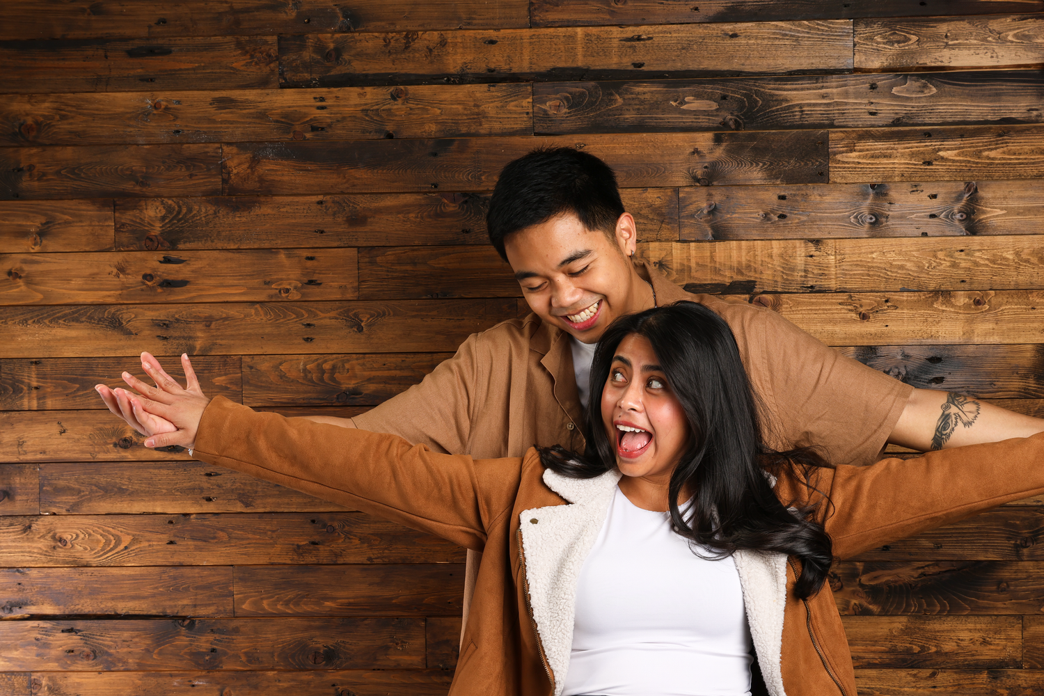 Couple embracing during a studio session in Edmonton. Surprise engagement