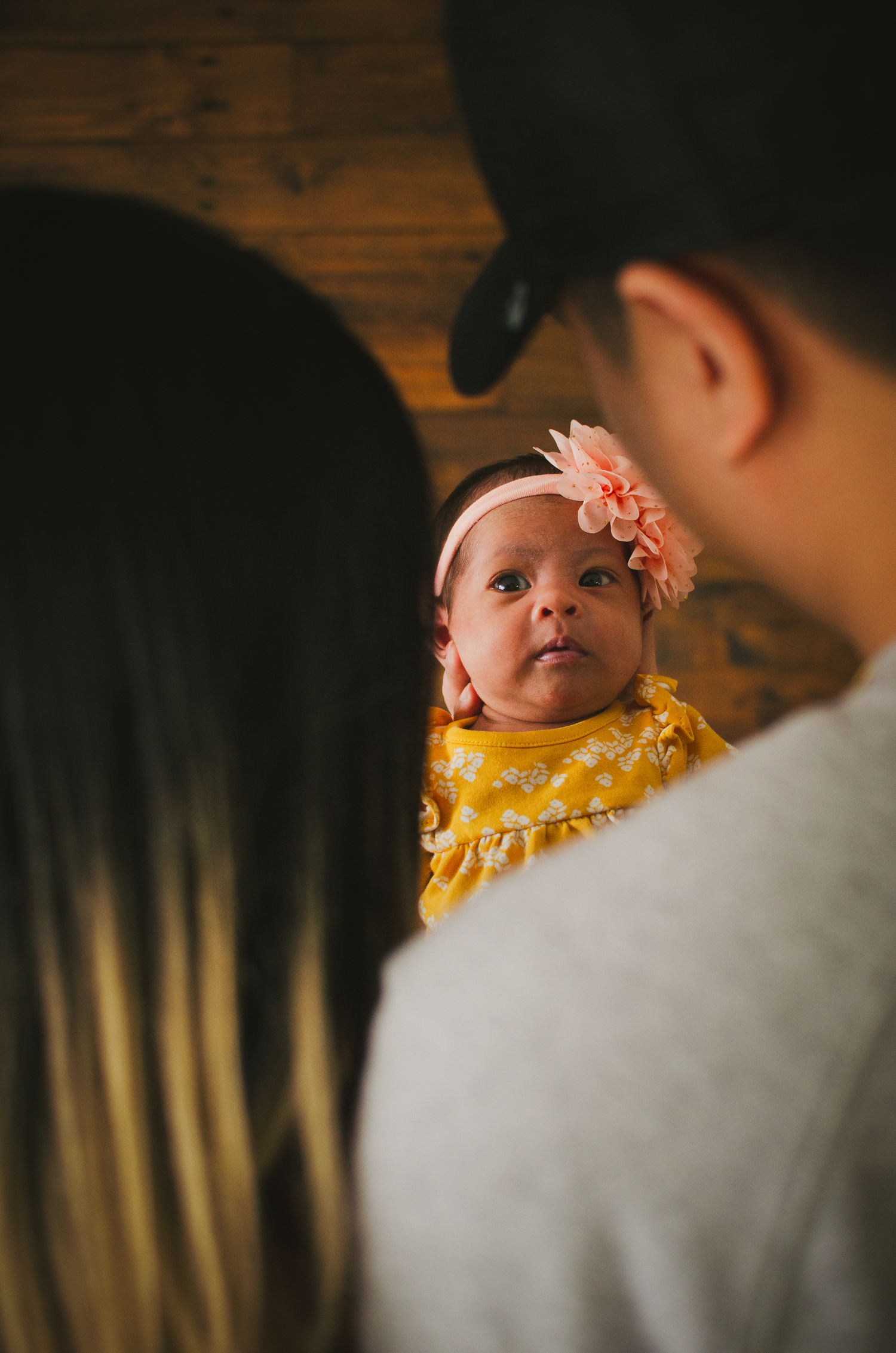Parents holding and watching their newborn baby during a lifestyle studio session in Edmonton.

creative shot