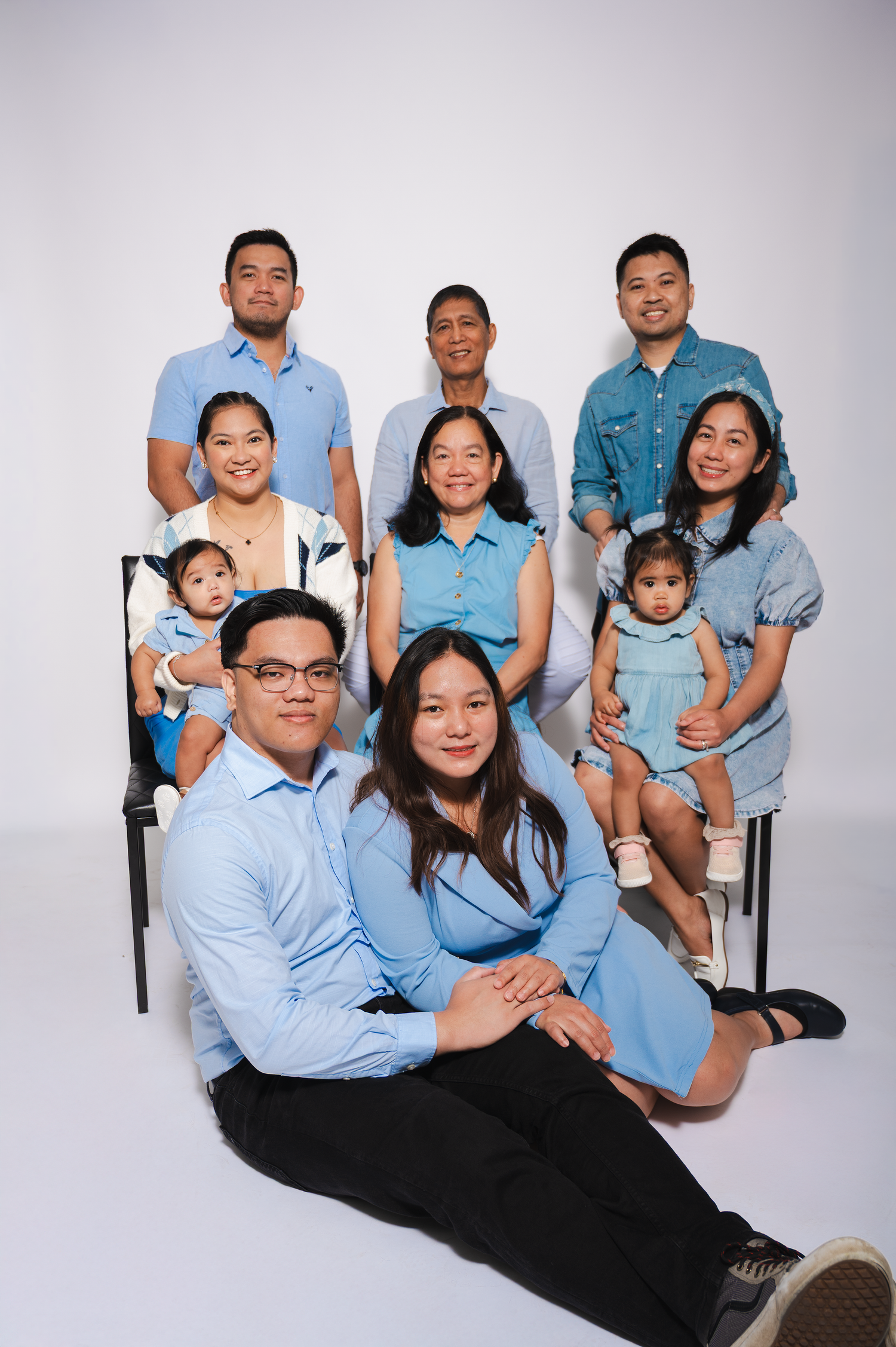 Family of ten posing together in a studio photography session in Edmonton.

extended family. with grand kids. newborn