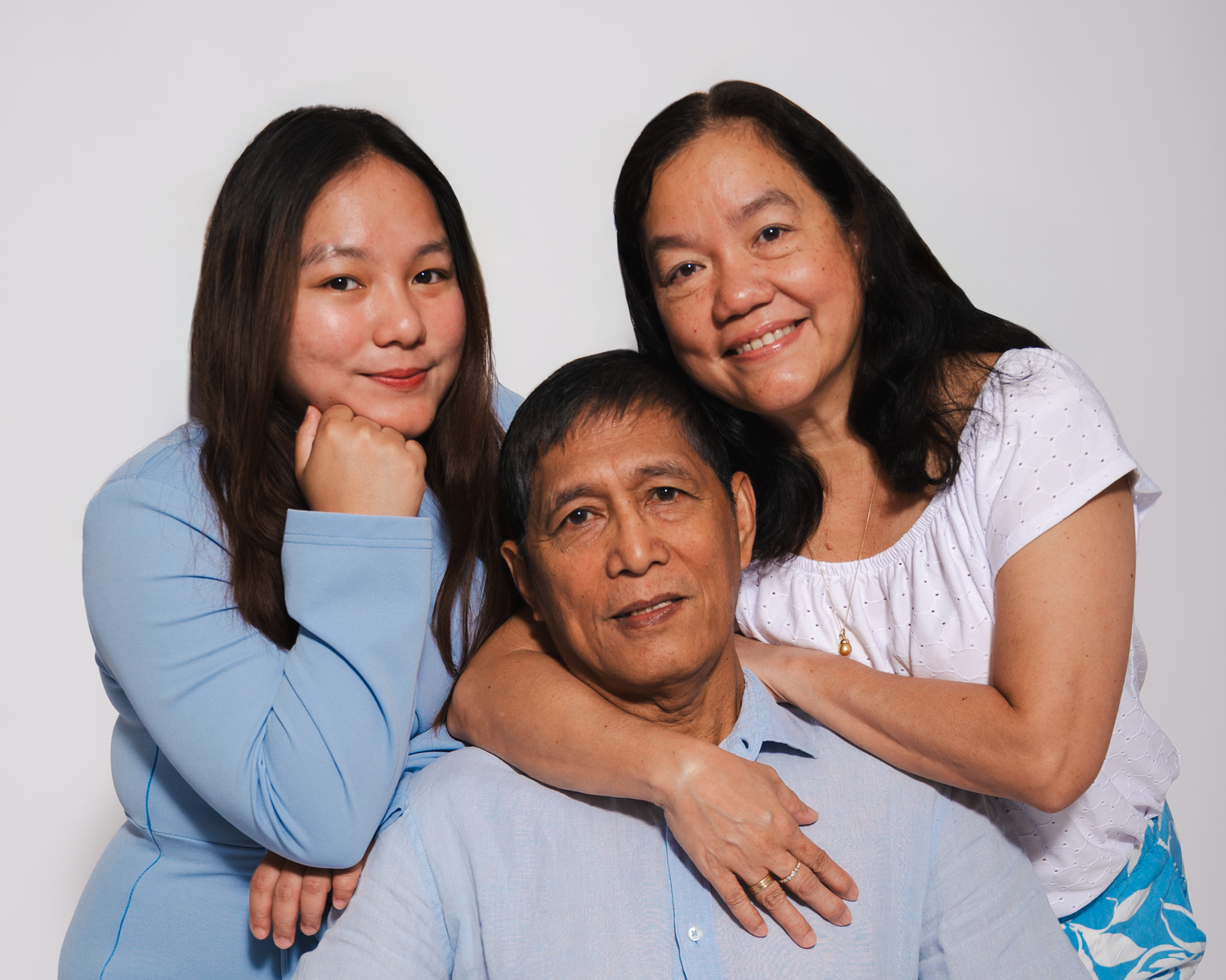 Professional studio family portrait session in Edmonton.
parents and daughter enjoying a studio photography session in Edmonton.