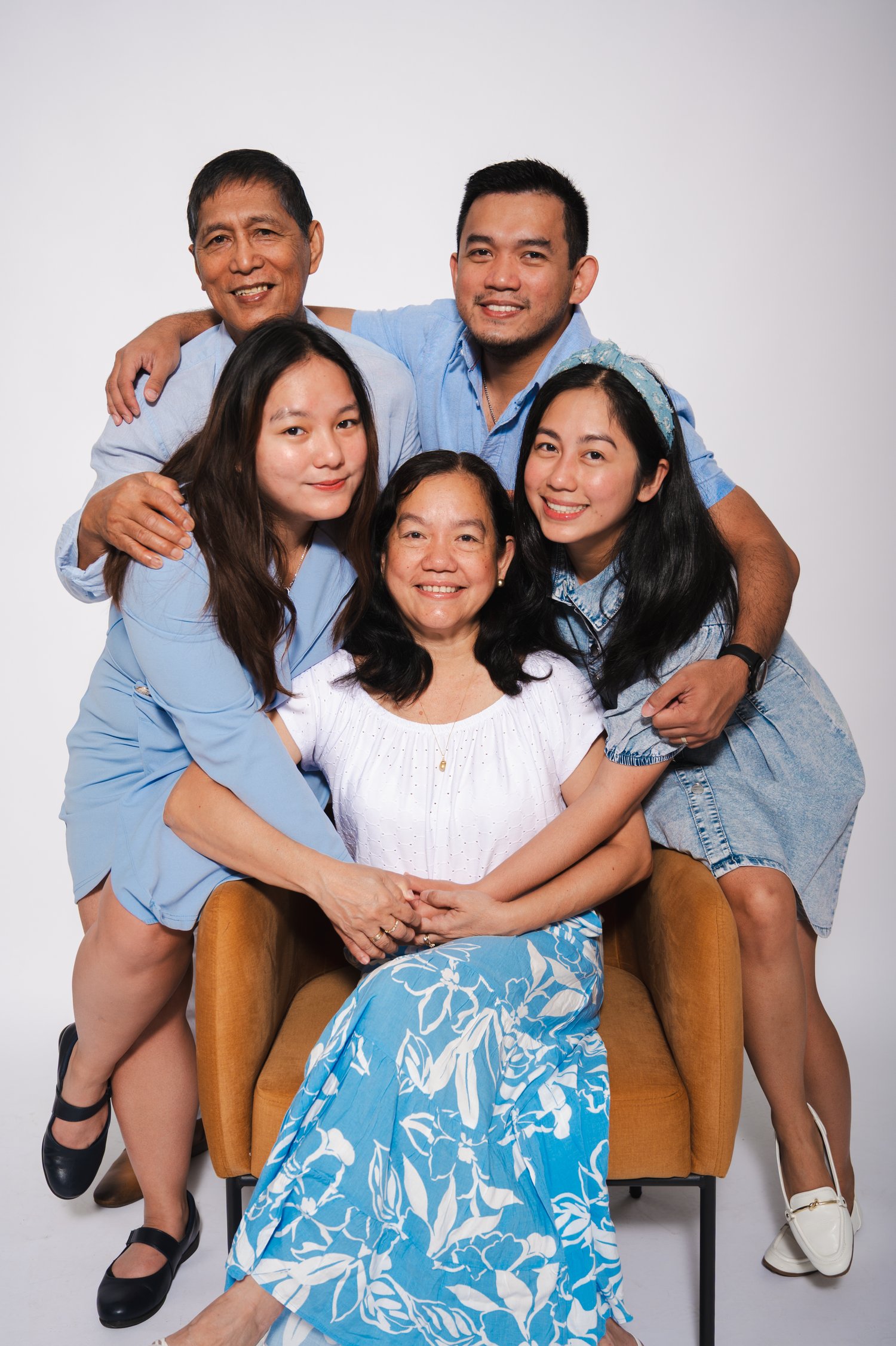 Family of five embracing together in a studio photography session in Edmonton.