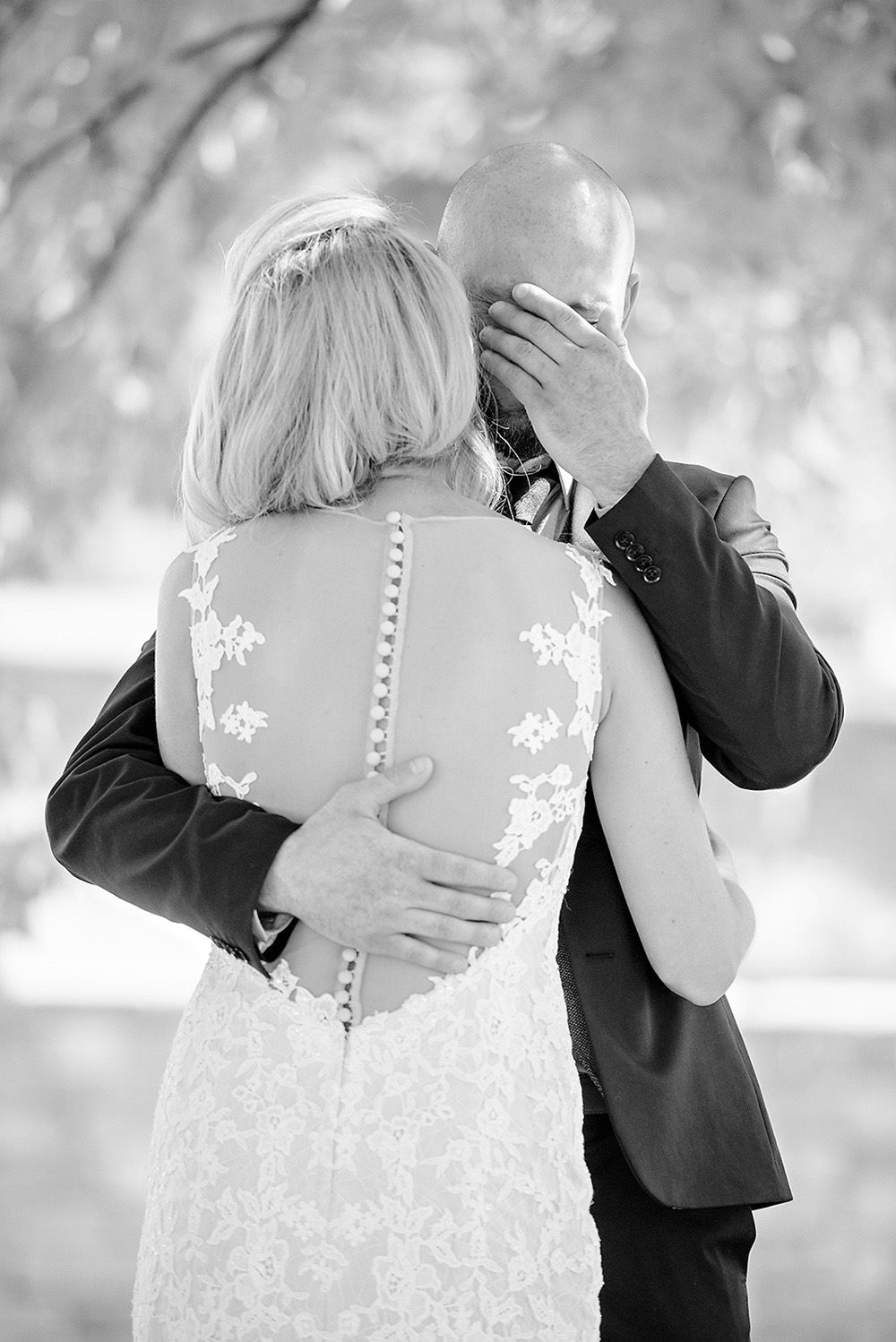 A couple embraces in a romantic black and white photo from their wedding day at Heritage Barn in Stow.