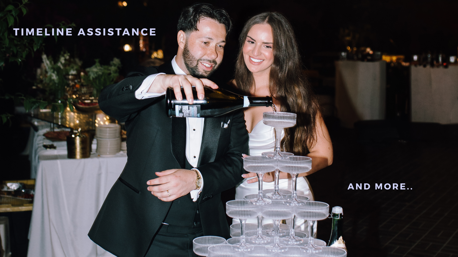A couple pours champagne into a tower of glasses at an elegant evening wedding reception.