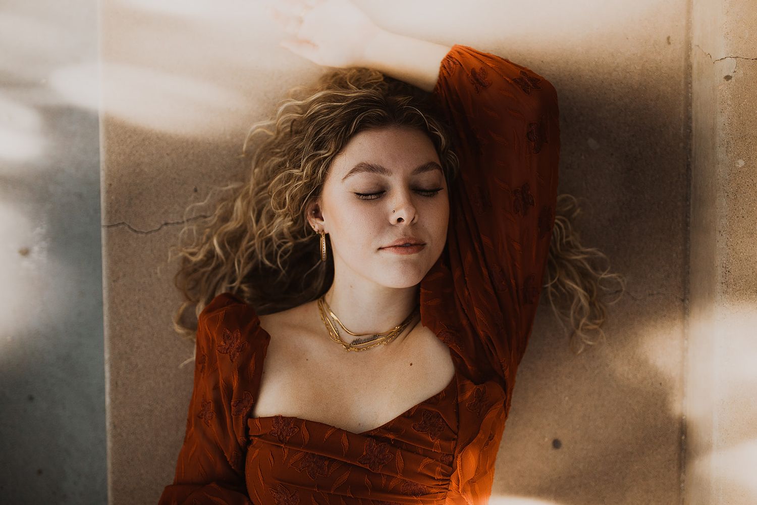 A series of dreamy portraits showing a person with flowing red hair against a soft, ethereal background.