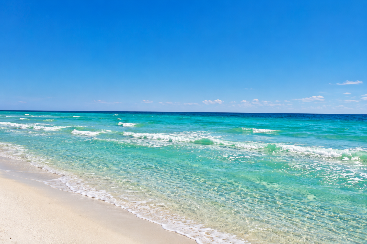 Turquoise ocean
Turquoise ocean waves meeting a pale sandy beach beneath a clear blue sky.