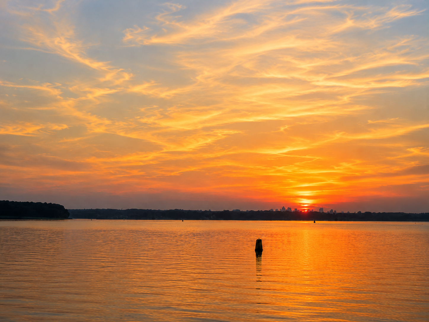 Golden sunset over water
Golden sunset reflecting across calm water under a softly colored sky.
