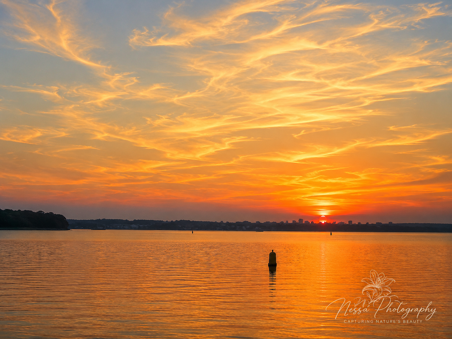 Golden sunset over water
Golden sunset reflecting across calm water beneath a warm orange sky.