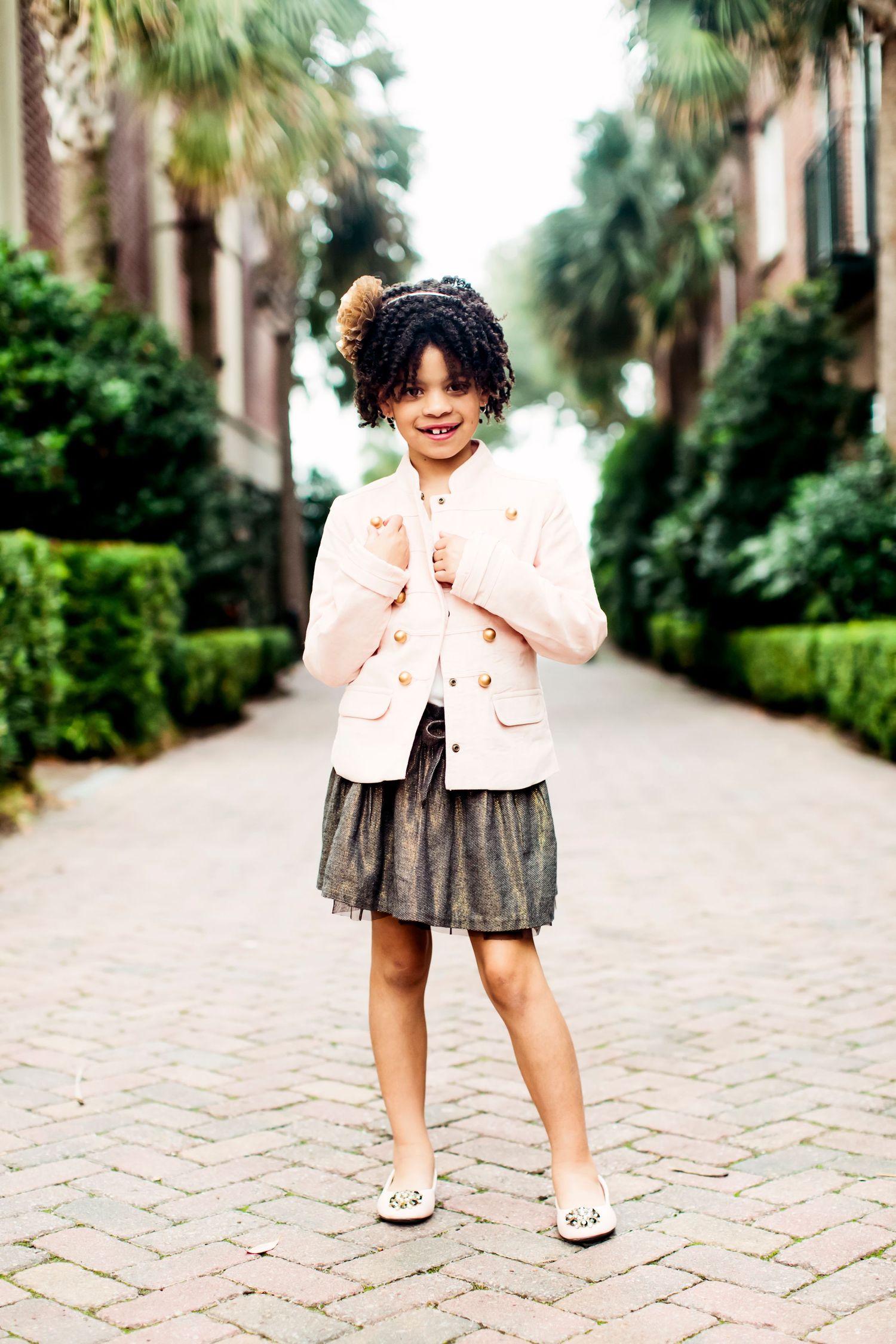 Happy little girl standing on brickwalkway in Historic Charleston SC