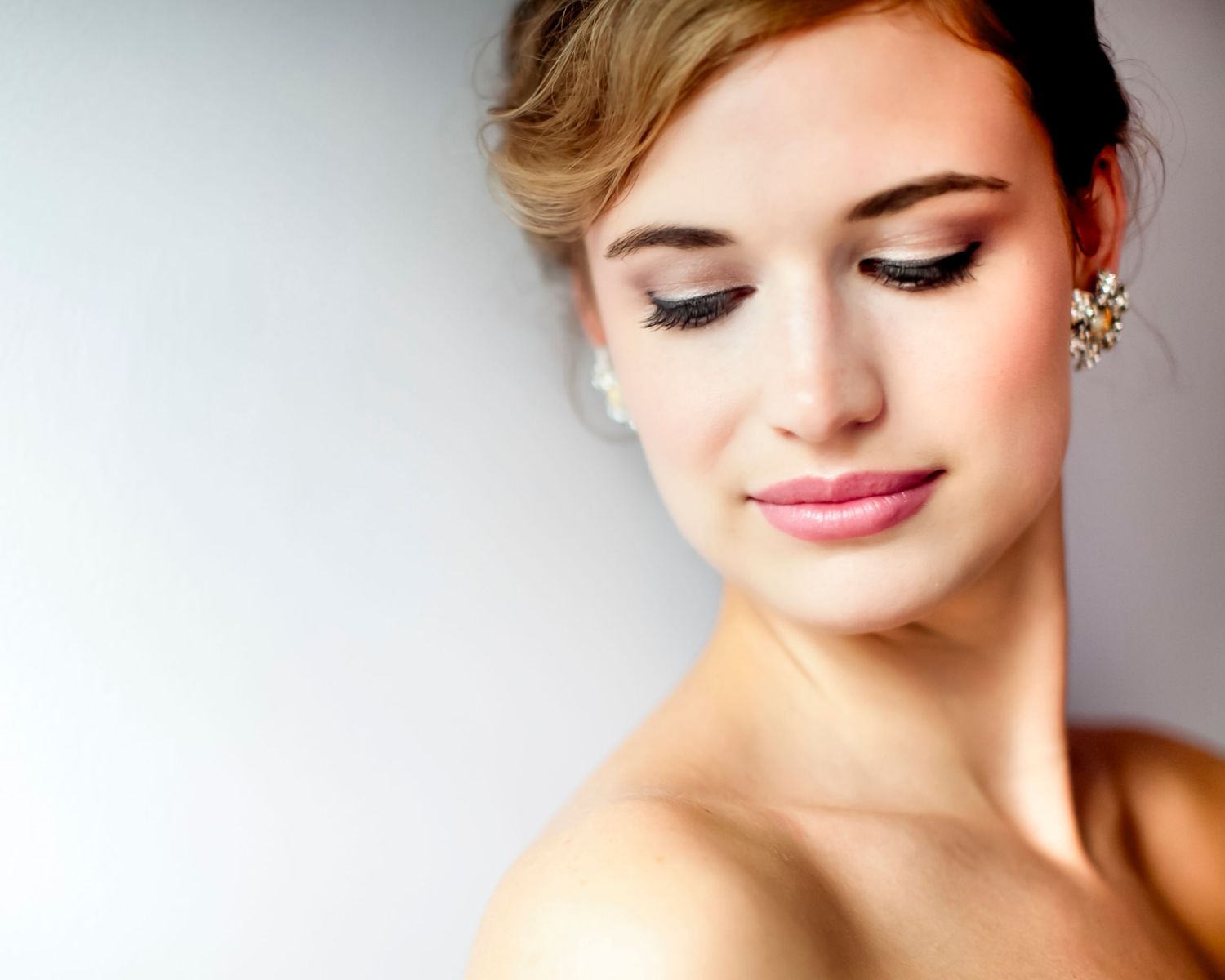 Editorial portrait of a woman with sparkling earrings looking downward, by Georgetown SC portrait photographer Juliet Elizabeth