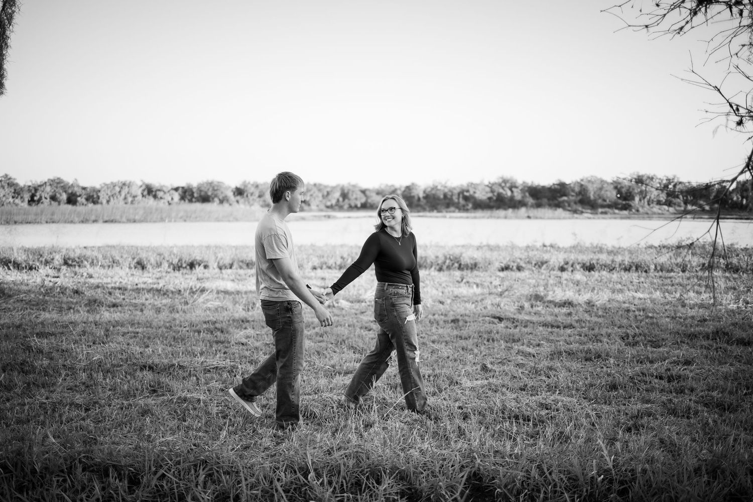 A sequence of black and white photos showing two people dancing together in a field.