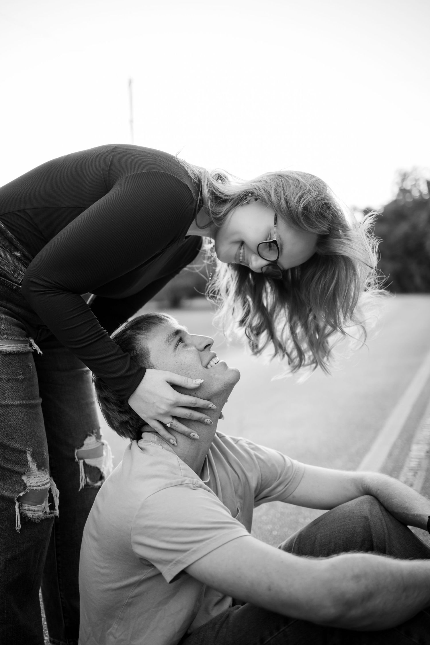 A playful black and white photo sequence of a couple sharing intimate moments outdoors.