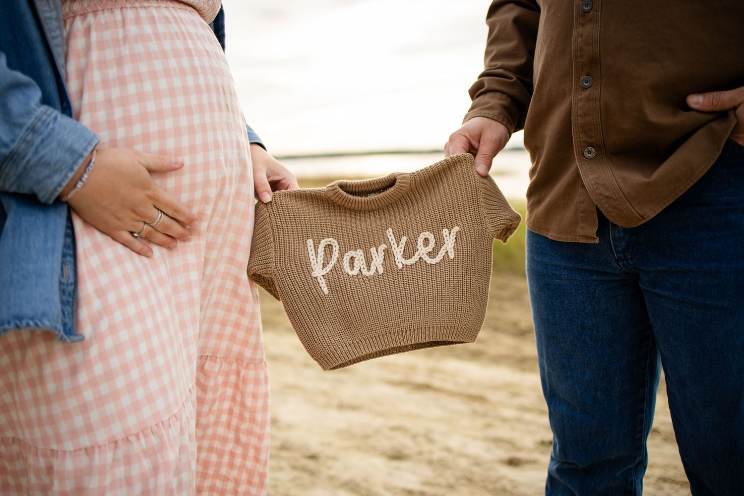 Close-up details of couple's casual outfits with denim and gingham dress.