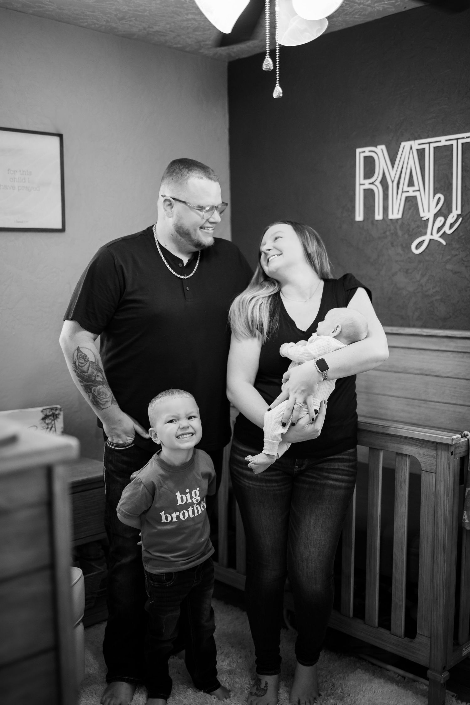 Black and white photo series showing tender family moments with a baby and individuals in casual attire at home.