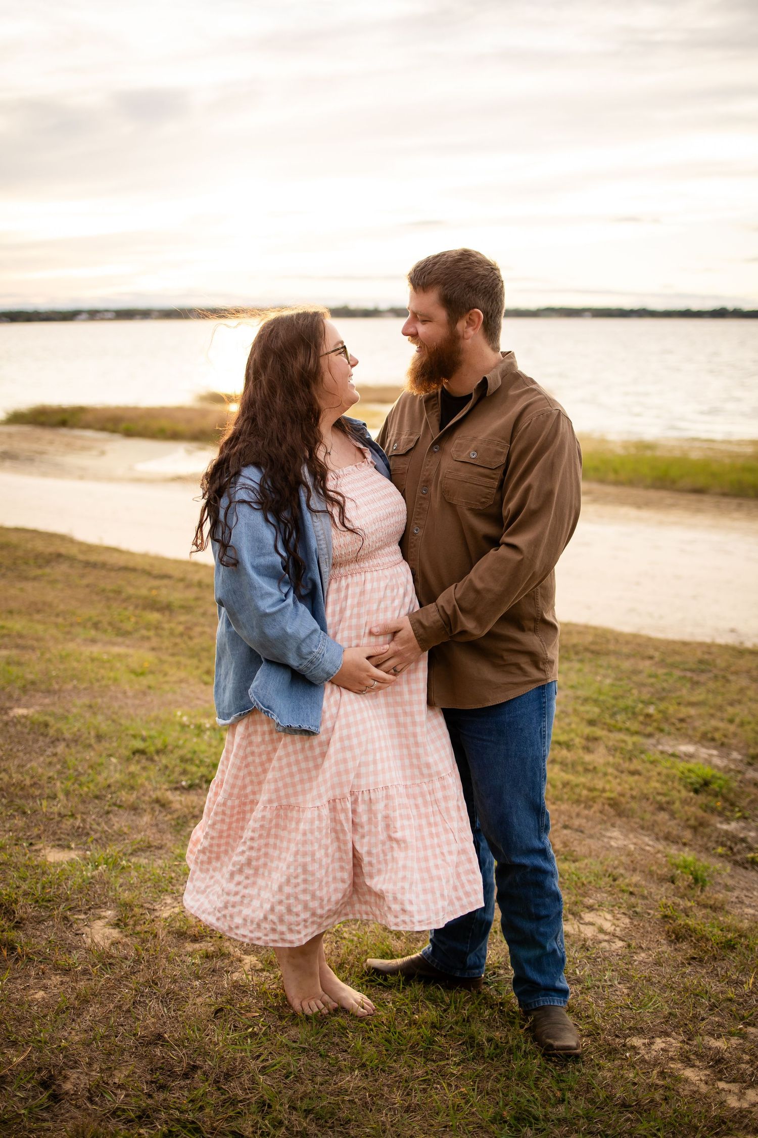 Romantic couple photos captured at sunset by the waterfront.