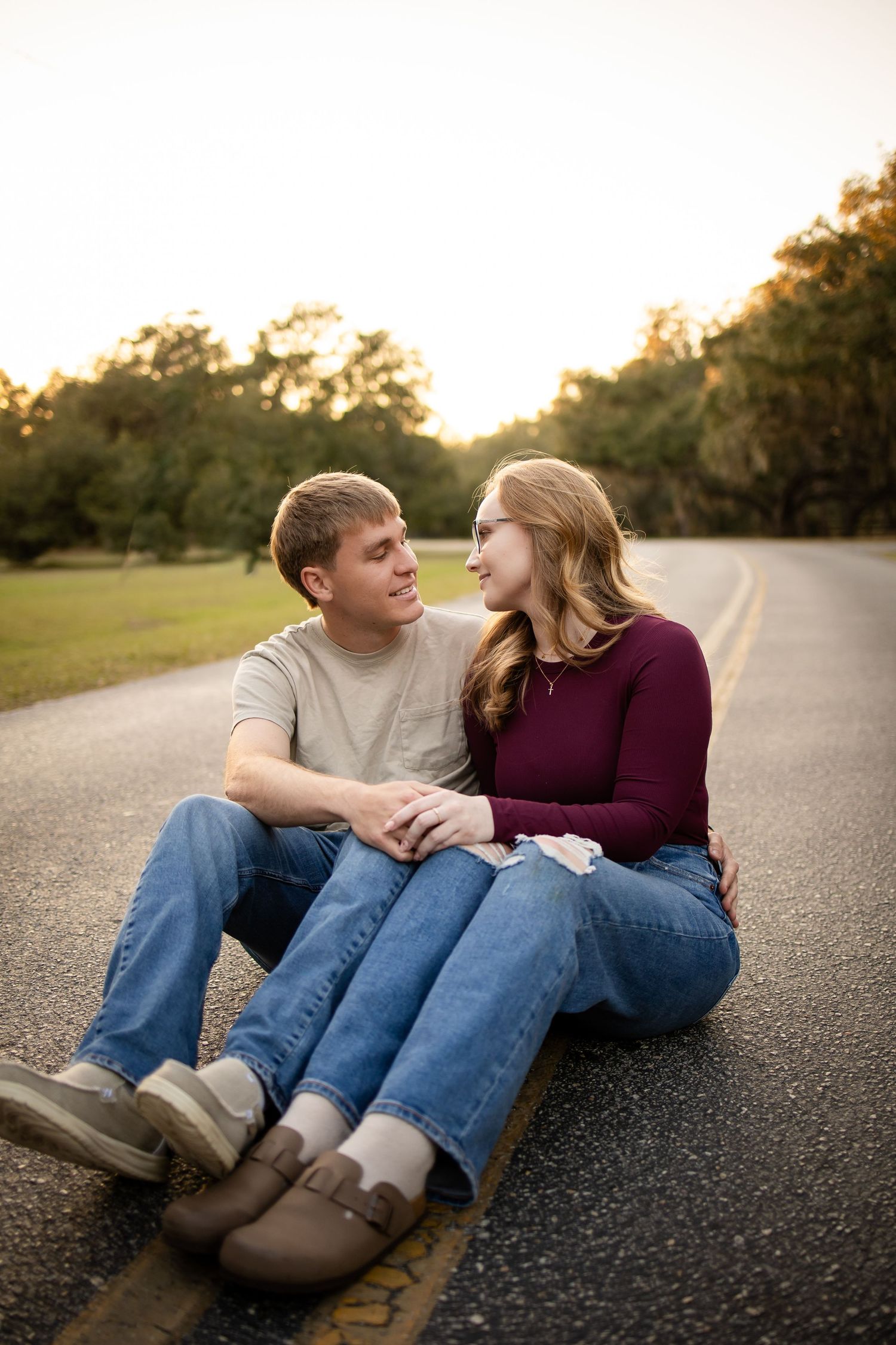 Couple sitting together on a road having an intimate conversation at dusk.