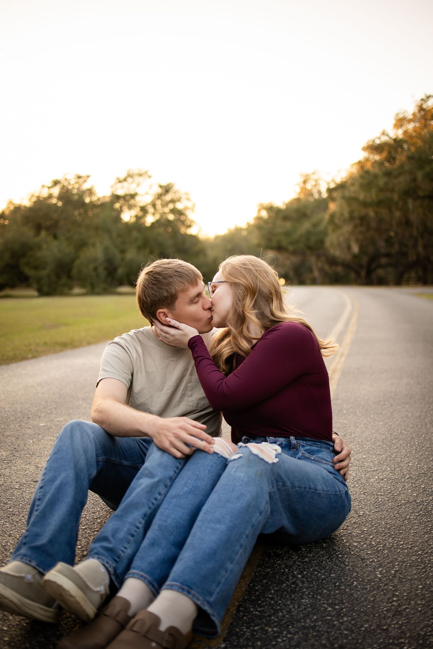 Intimate couple portrait session on a quiet road during golden hour.