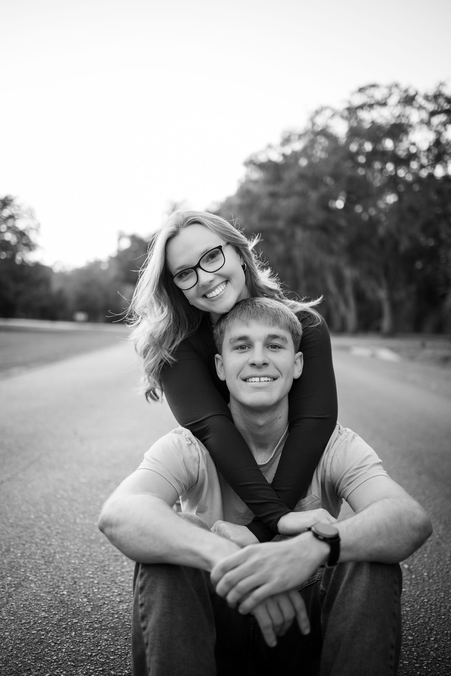 Black and white portraits captured on an empty road with natural lighting.