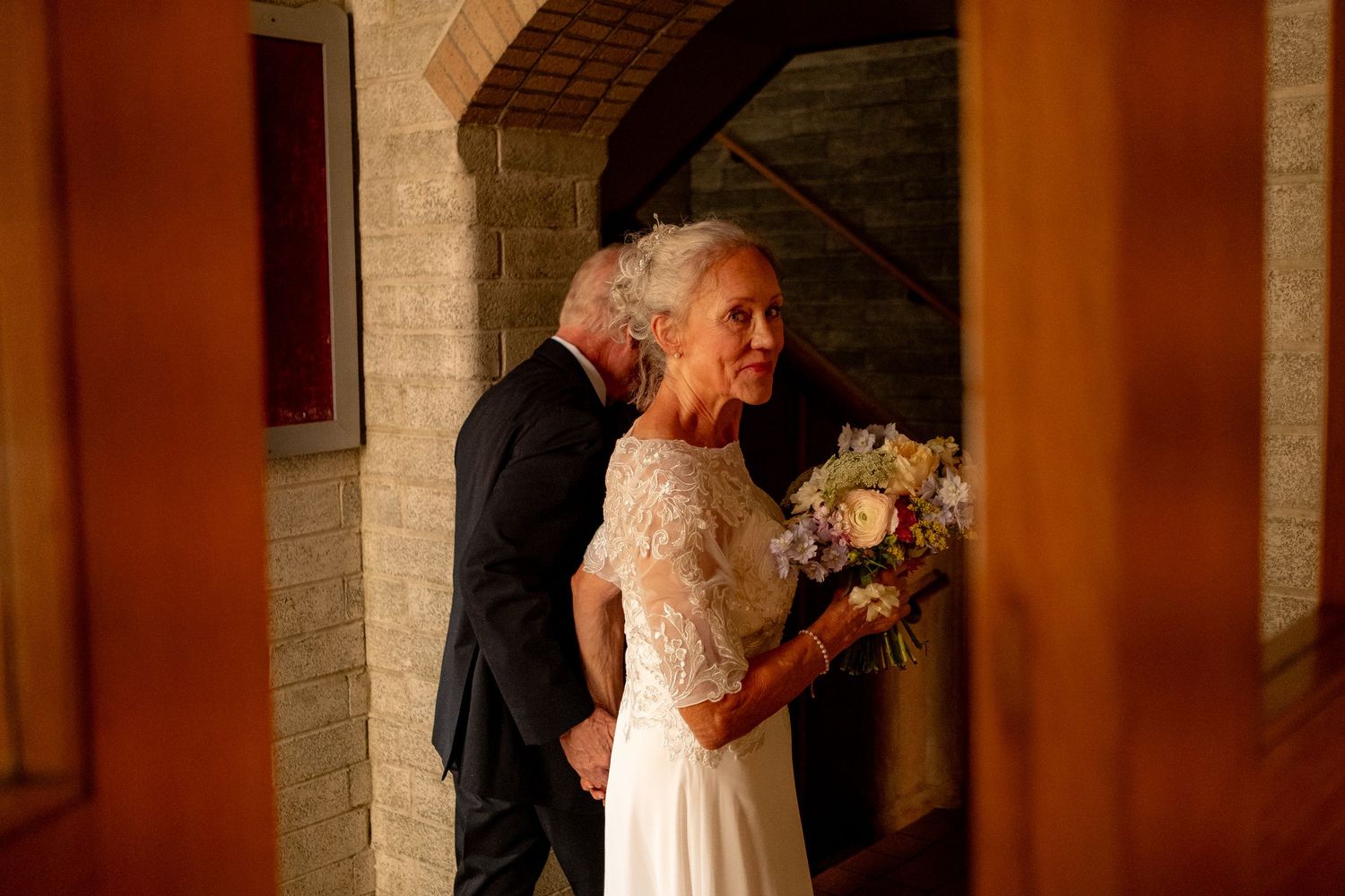 A bride and groom share a tender moment during a first dance at their wedding reception.
