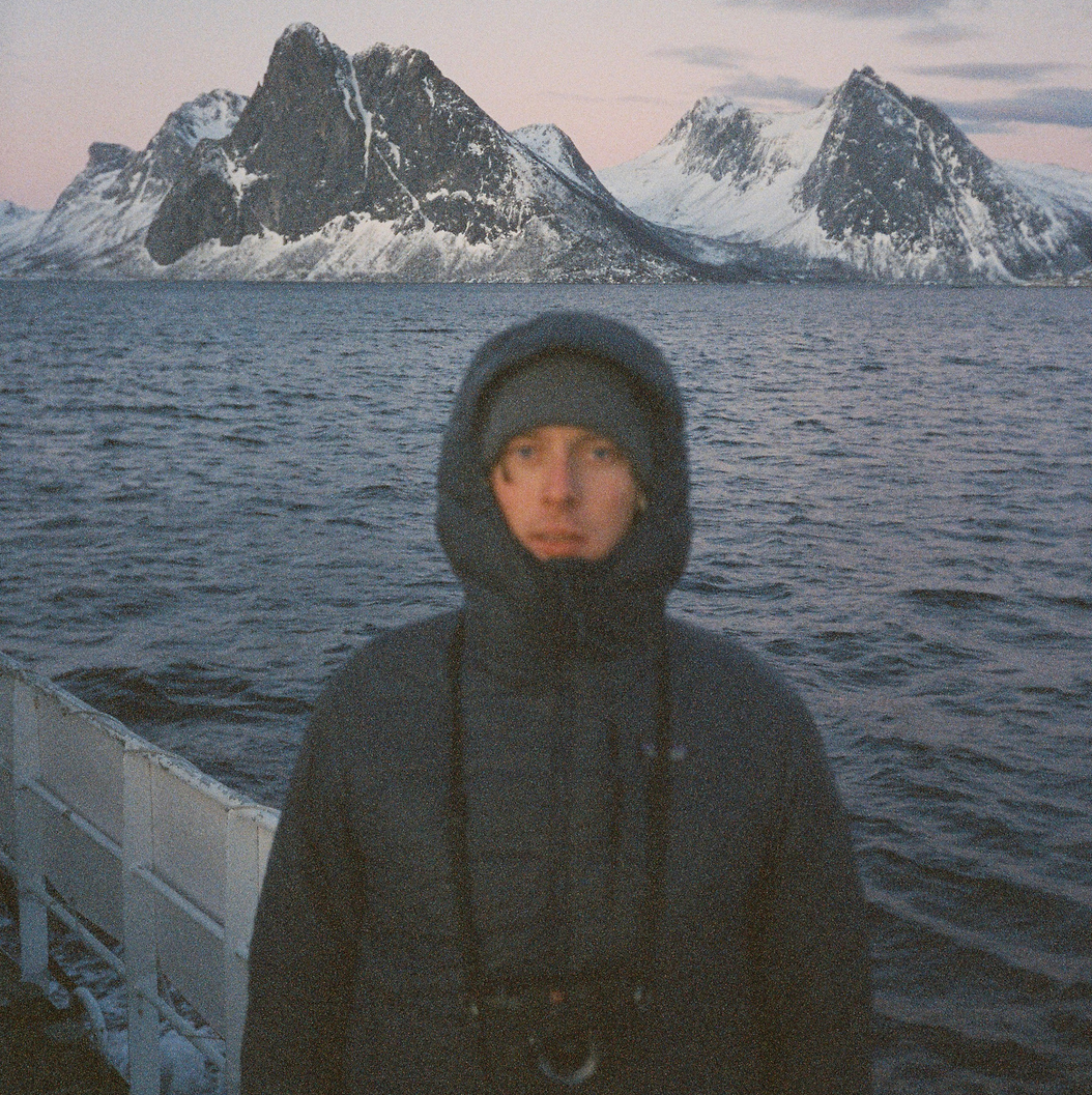 A panoramic sequence of someone bundled in winter gear against the backdrop of snowy Antarctic mountains and waters.